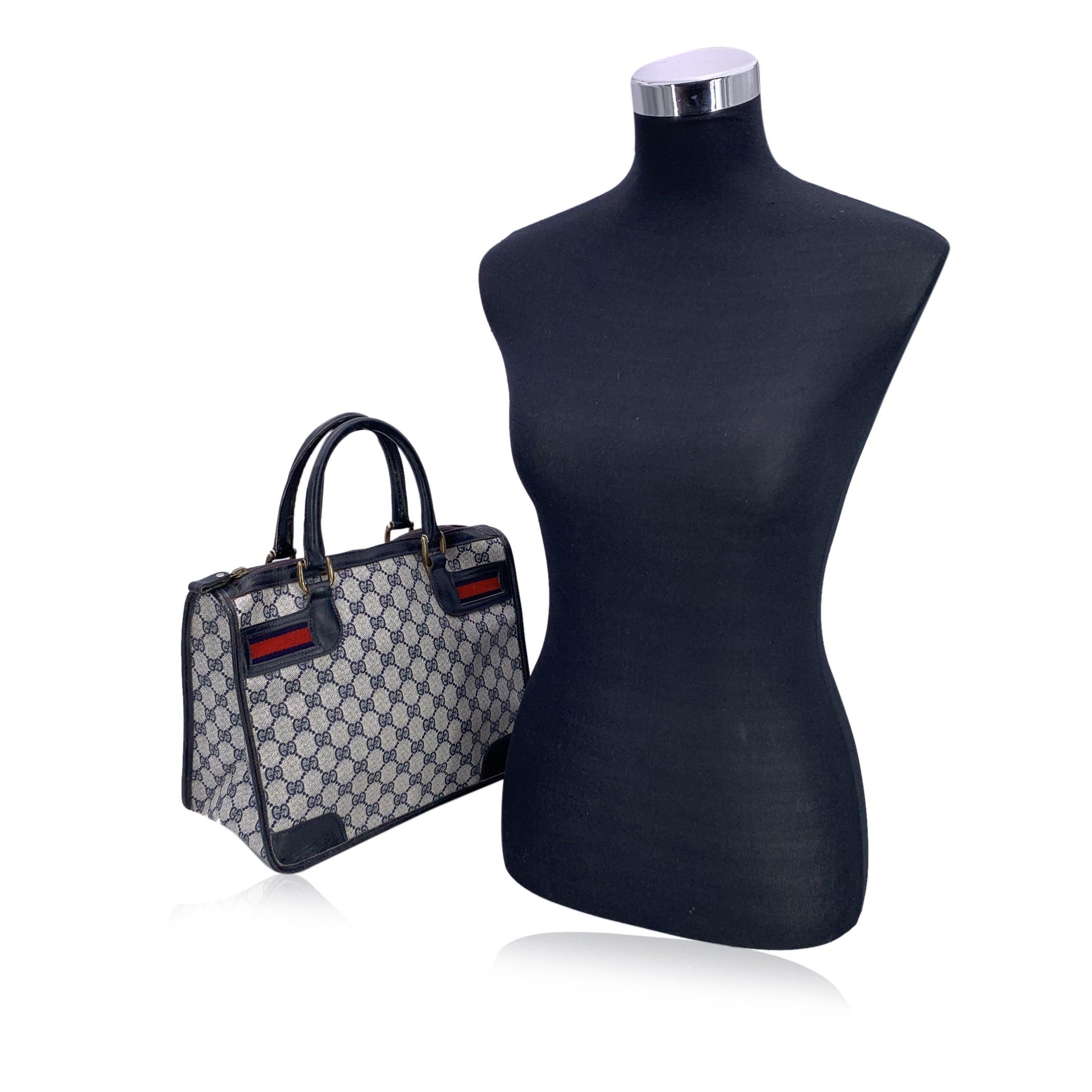 Step into a world of timeless sophistication with this beautiful vintage Gucci satchel, a true icon of luxury and style. Crafted from the brand's signature blue monogram canvas, this bag is trimmed with rich blue leather, enhancing its elegant and