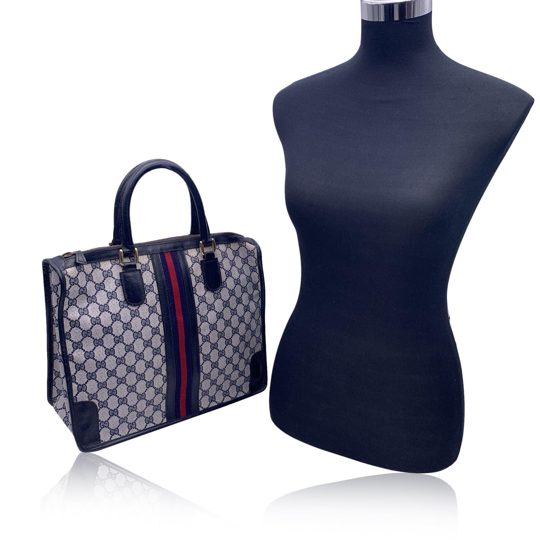 Beautiful Gucci satchel made in blue monogram canvas with blue leather trim and handles. Blue/Red/Blue stripes on the front and on the back. Upper zipper closure. Blue lining. 1 side zip pocket inside. 'Made in Italy by GUCCI' tag inside Condition B