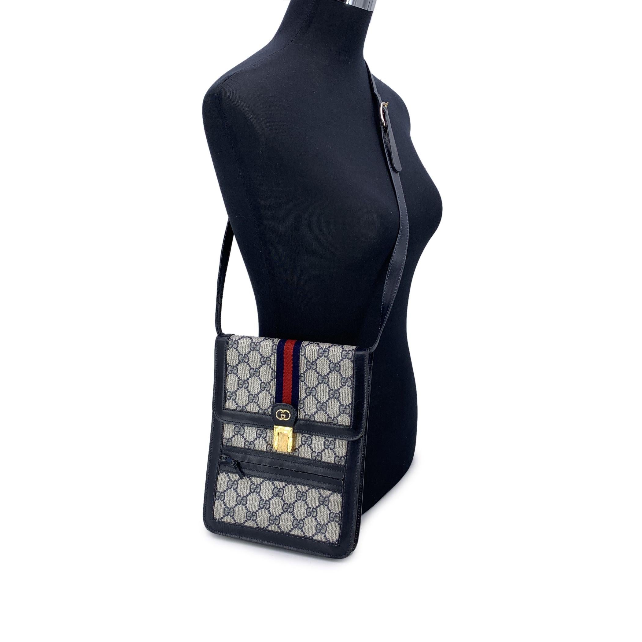Step back into a time of effortlessly chic elegance with this vintage Gucci 'Ophidia' Vertical Messenger Bag, a perfect blend of classic design and modern functionality. Crafted in iconic blue monogram canvas, this bag is trimmed with rich blue