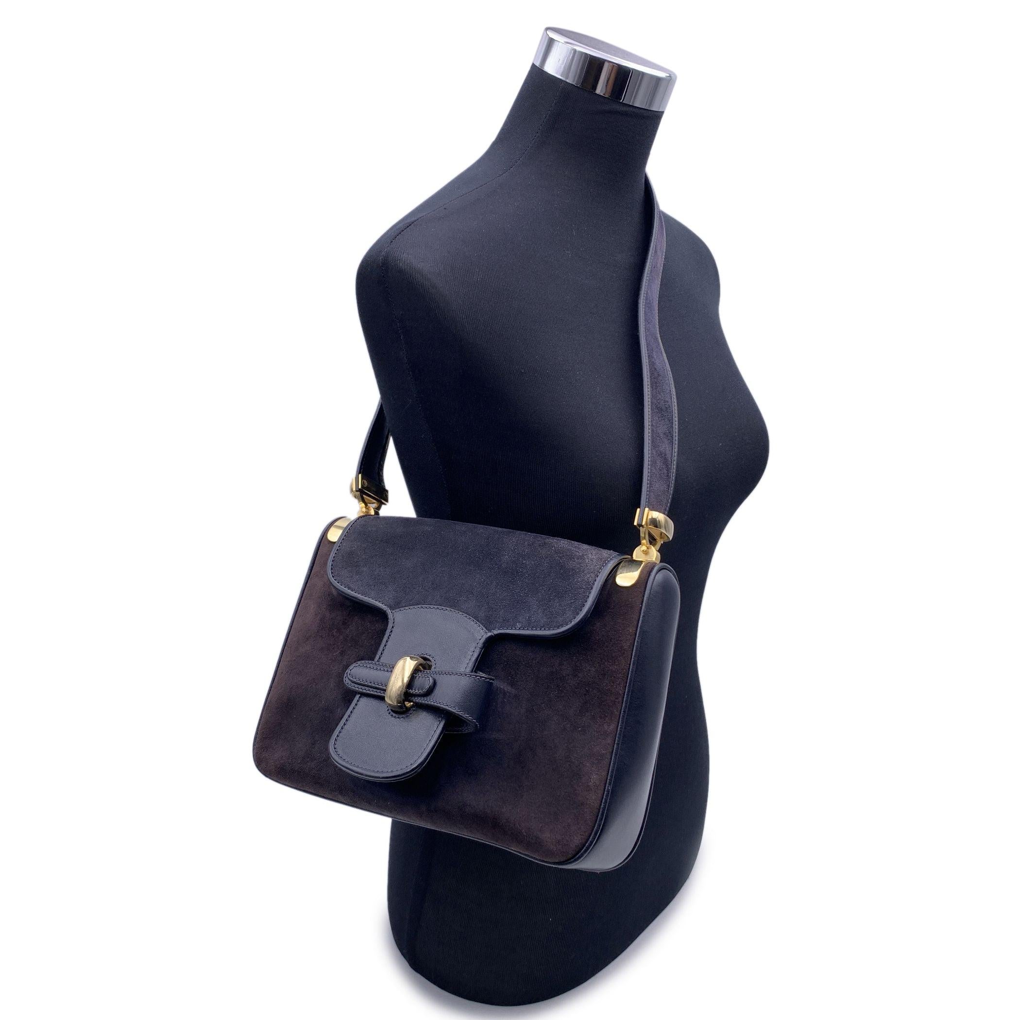 Vintage Gucci shoulder bag in blue suede and leather. Flap closure with gold metal hardware on the front. Blue leather lining. 1 side zip pocketinside. 'GUCCI Boutique - Made in Italy' embossed inside Condition B - VERY GOOD Some fading and pressure