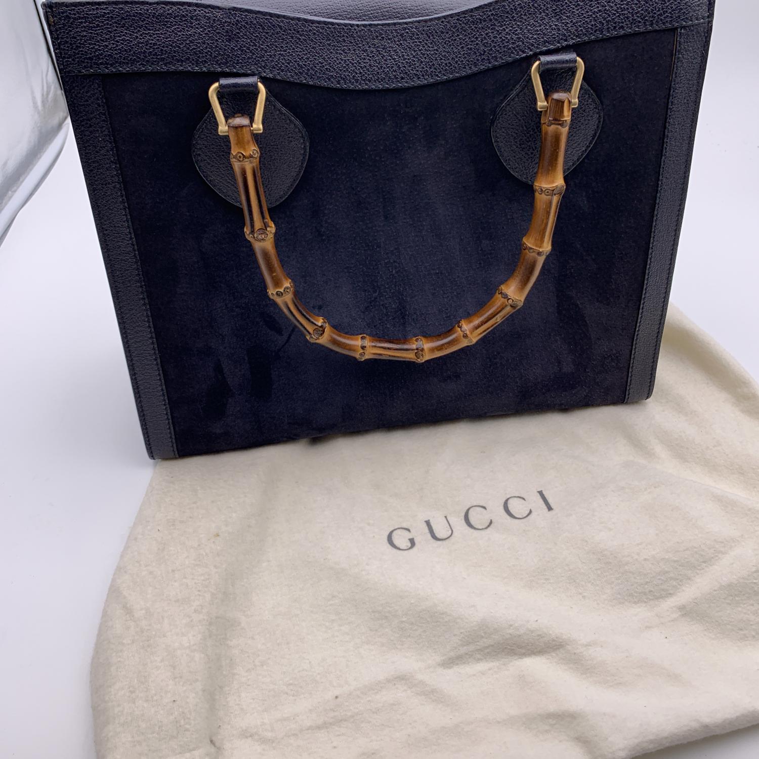 Beautiful Gucci Bamboo tote bag in blue suede with genuine leather trim. Double distinctive Bamboo handle. Princess Diana, was snapped carrying a this model on several occasions. Magnetic button closure on top. 5 bottom feet. Gold metal hardware. 1