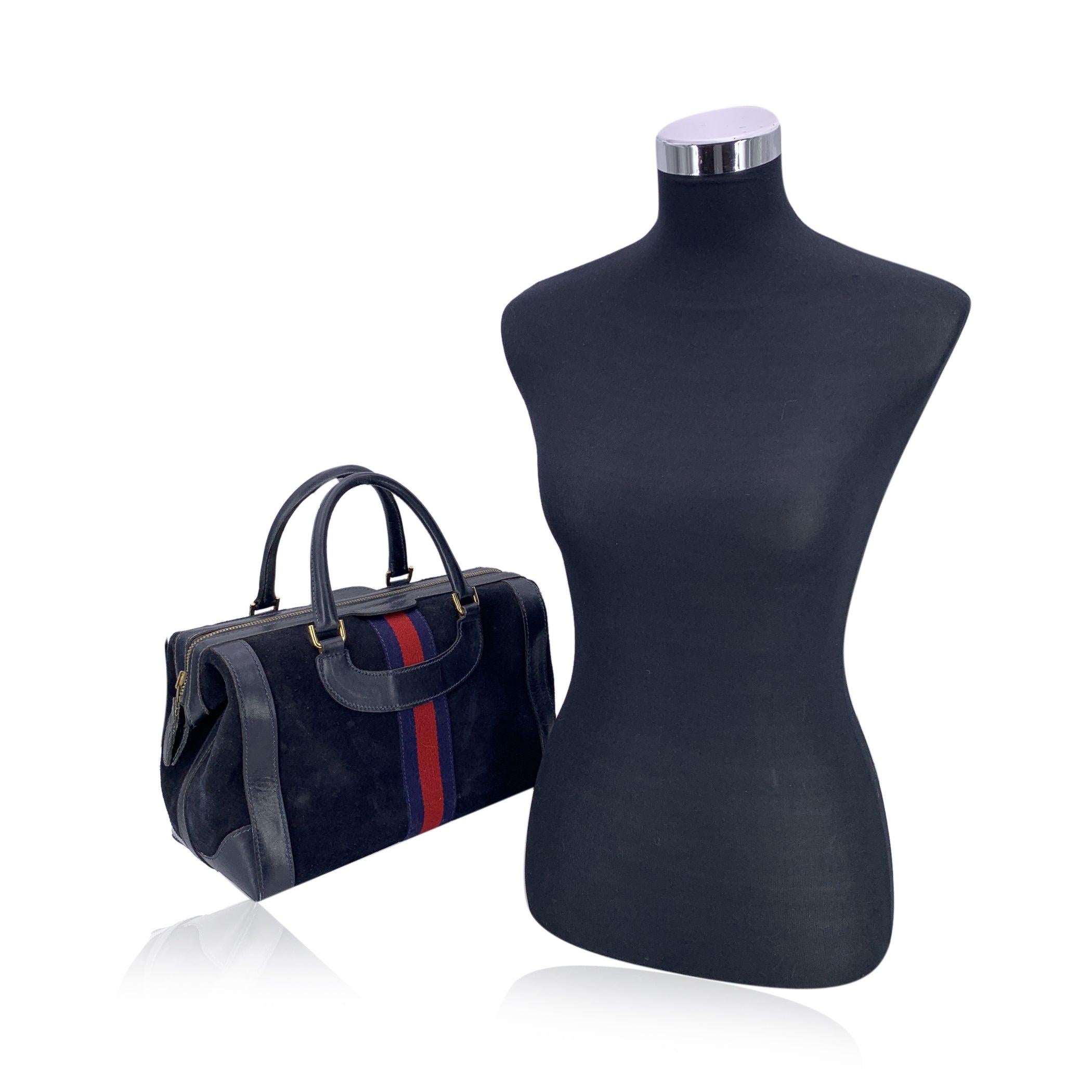 This beautiful Gucci Boston Bag is a timeless classic that effortlessly blends style with practicality. Crafted from blue suede and leather, the bag is accented with blue leather trim and handles, creating a refined and elegant look. The iconic