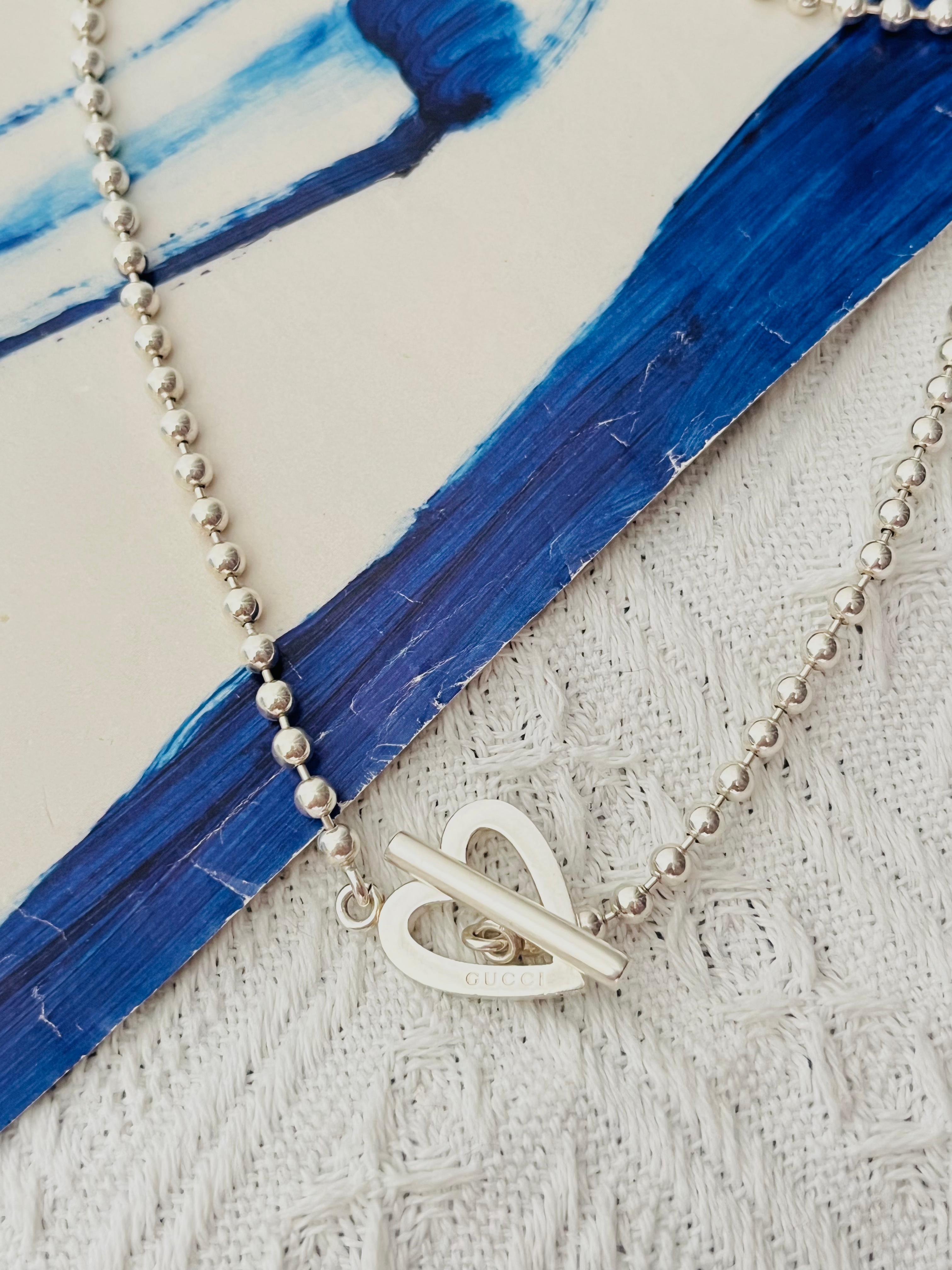 Gucci Vintage Unisex Boule Logo Heart Love Ball Dots Chain Toggle Modernist Necklace, Sterling Silver

Very excellent condition. Light scratches, barely noticeable. 100% genuine. 

Signed at the charm. Rare to find.

Material: 925 Sterling
