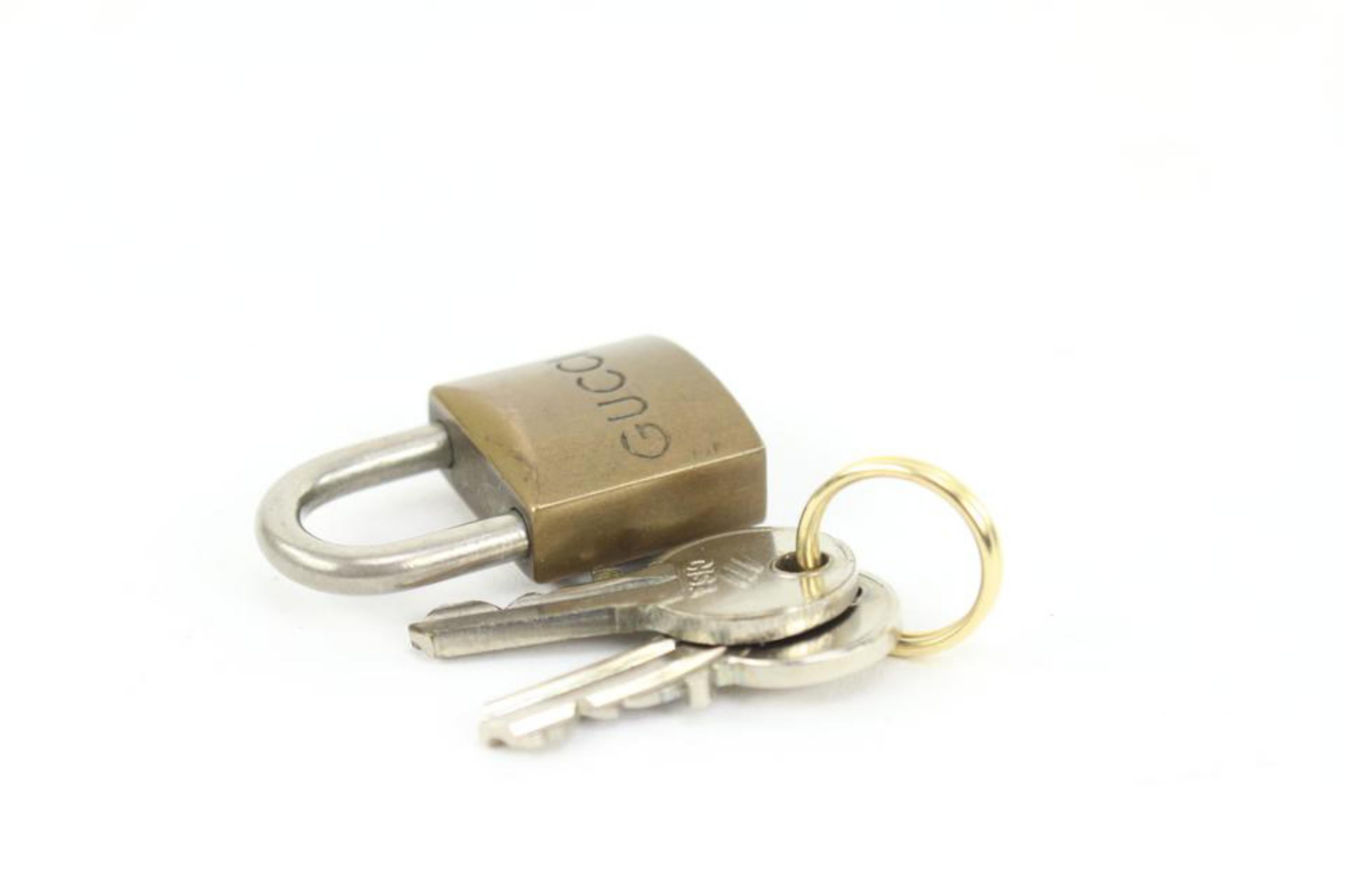 Gucci Vintage Brass Lock and Key Set Cadena Padlock Bag Charm 17g34s
Measurements: Length:  .6