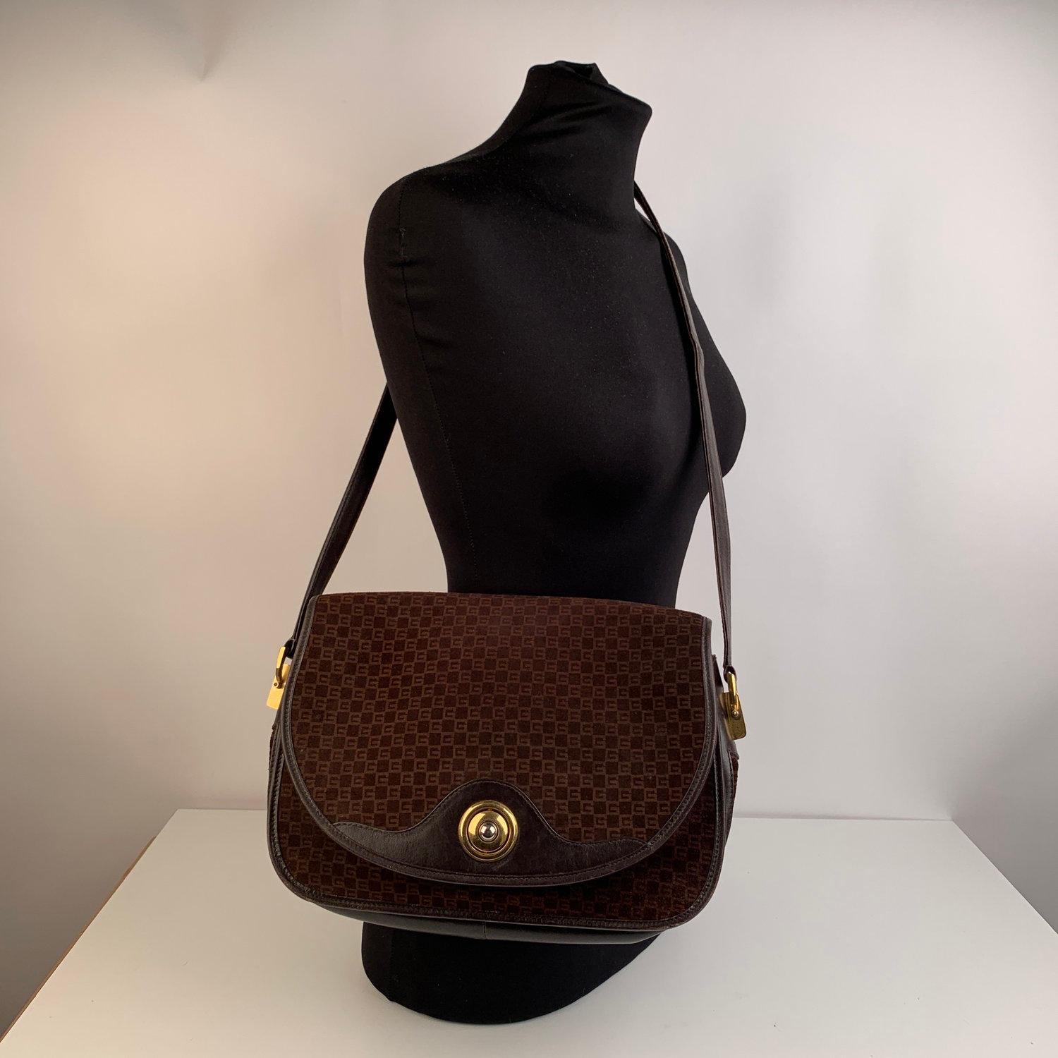 Vintage Gucci messenger or shoulder bag crafted in brown monogram suede with genuine brown leather trim. Small GG light brown monograms. Main flap closure. Internal leather lining. . Beige diamond lining . 3 compartments inside and a zipper pocket.