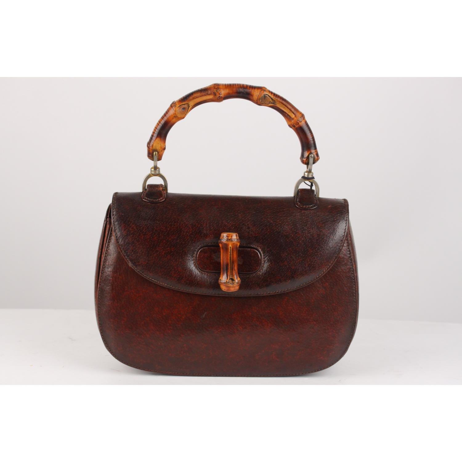 Rare GUCCI vintage Leather bamboo bag in brown leather. The bag features a looping bamboo top handle, a frontal flap, brass hardware and a bamboo turn lock. This is an iconic model created by GUCCI artisanals in 1947. The usage of bamboo might have