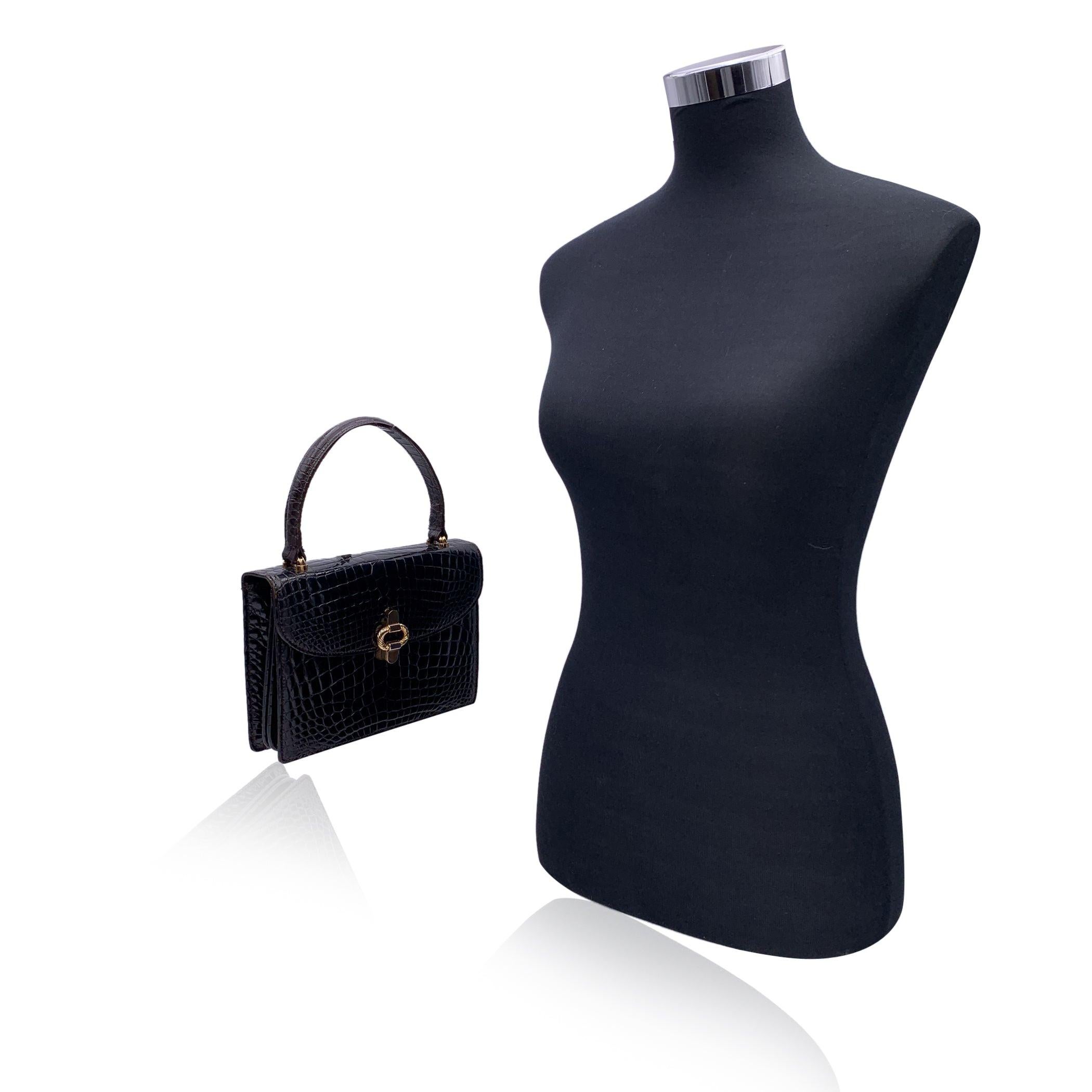 Beautiful Vintage Gucci handbag made in brown leather. Gold metal closure on the front. Top carry handle. Brown leather interior. 1 side zip pocket and 3 side open pockets. 'Made in Italy by Gucci' embossed inside. Condition B - VERY GOOD Some