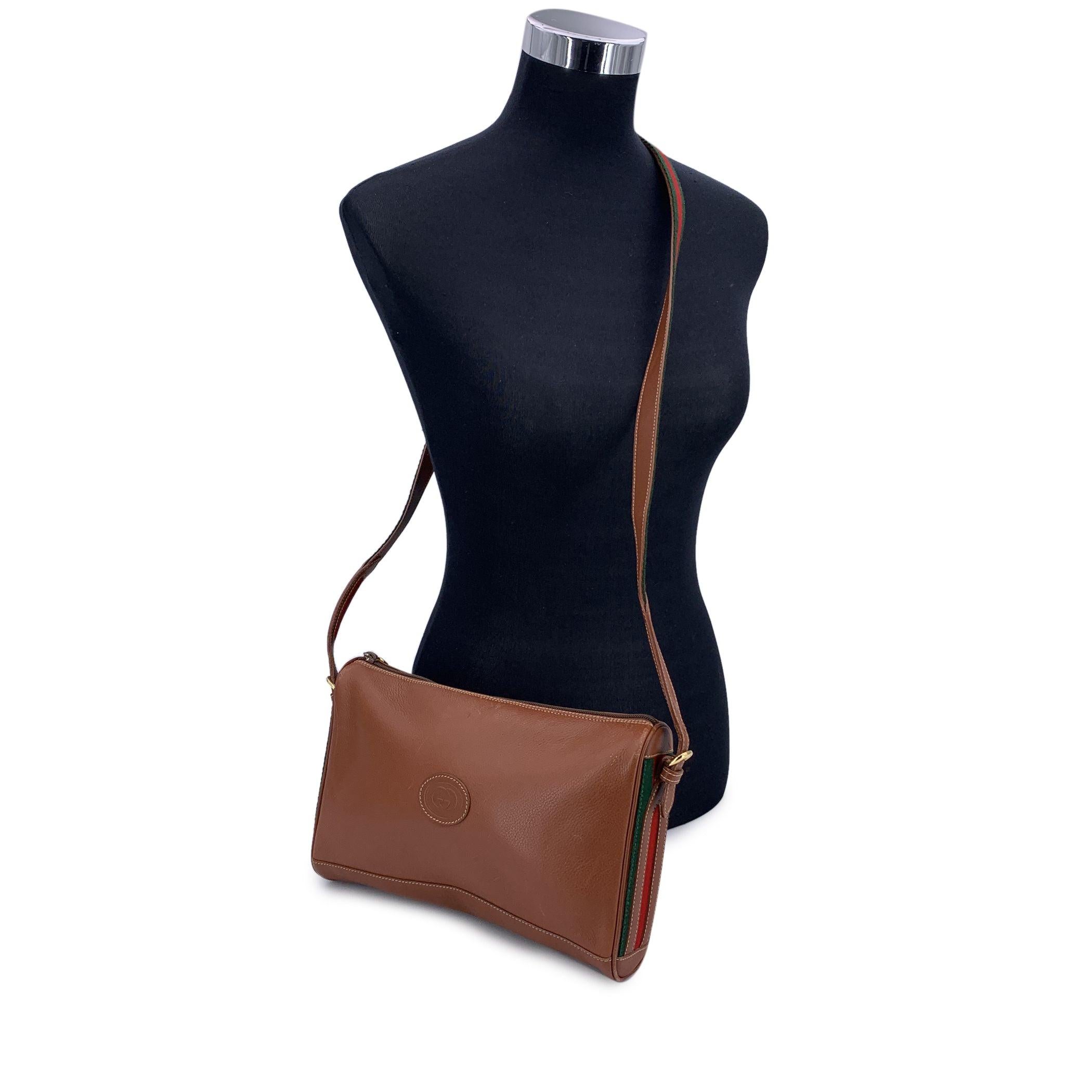 Gucci Vintage brown leather shoulder bag. GG - Logo patch on the front. Upper zipper closure. Brown suede. 1 side zip pocket inside. Adjustable shoulder strap. 'Gucci - Made in Italy' tag inside (with serial number on its reverse) Condition B - VERY