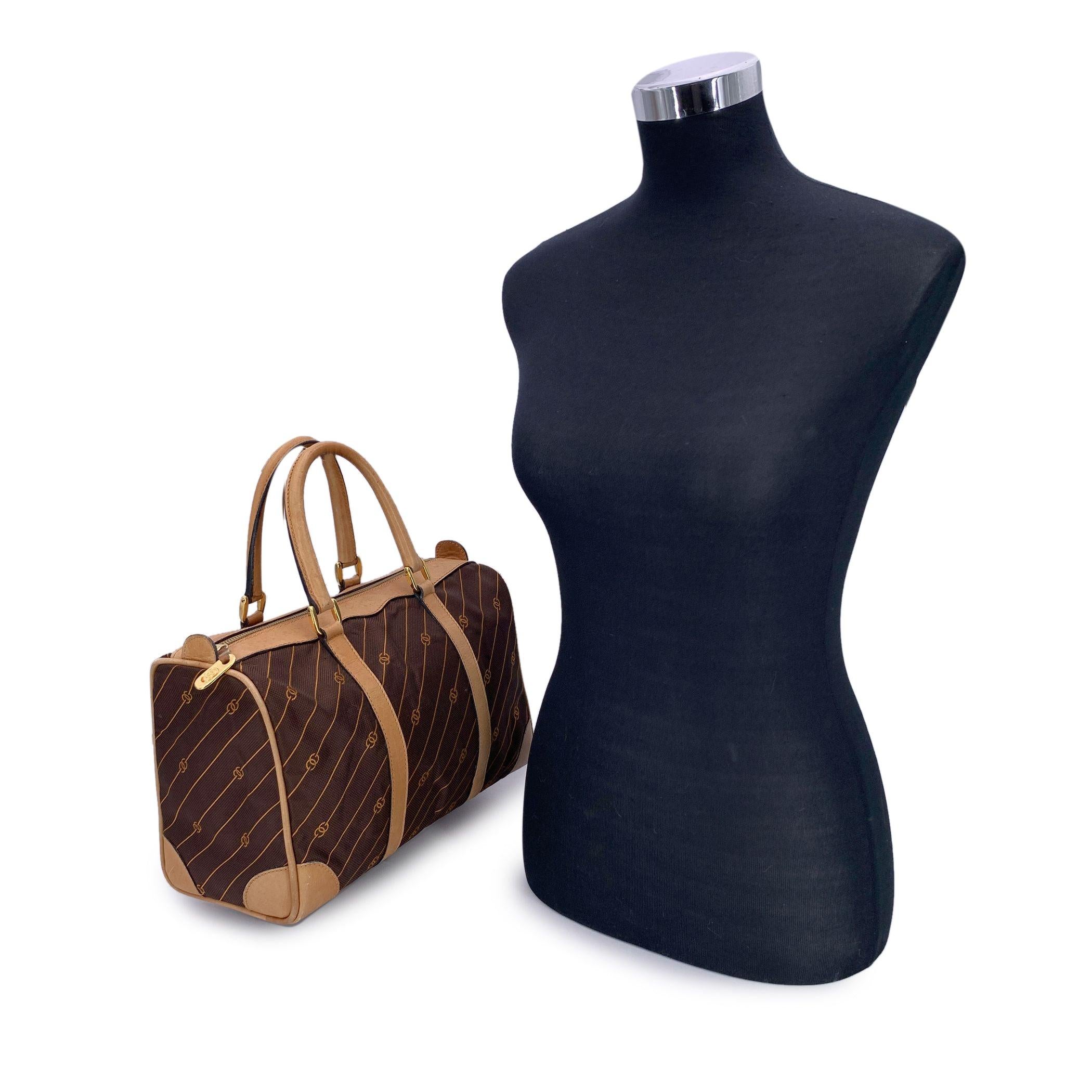 Embrace a piece of vintage luxury with this Gucci Boston Bag, a timeless classic that perfectly blends iconic design with practicality. Crafted in rich brown canvas adorned with Gucci's signature stripes and GG logo pattern in orange color, this bag