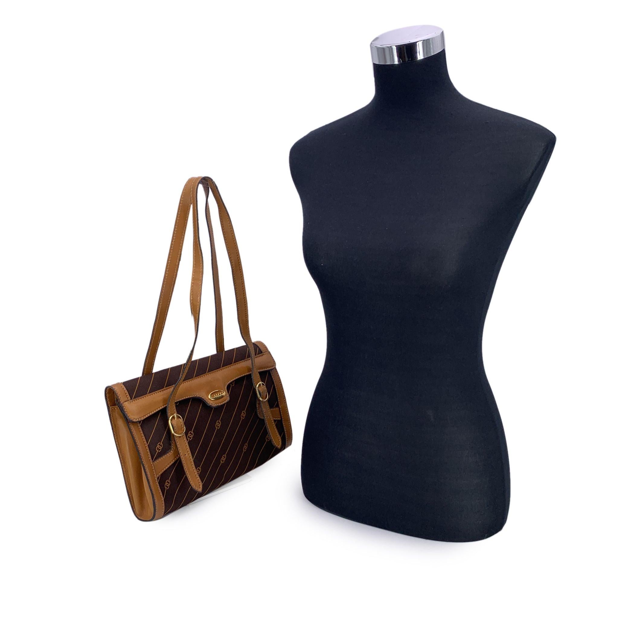 Embrace a piece of vintage luxury with this Gucci Shoulder Bag, a timeless classic that perfectly blends iconic design with practicality. Crafted in rich brown canvas adorned with Gucci's signature stripes and GG logo pattern in orange color, this