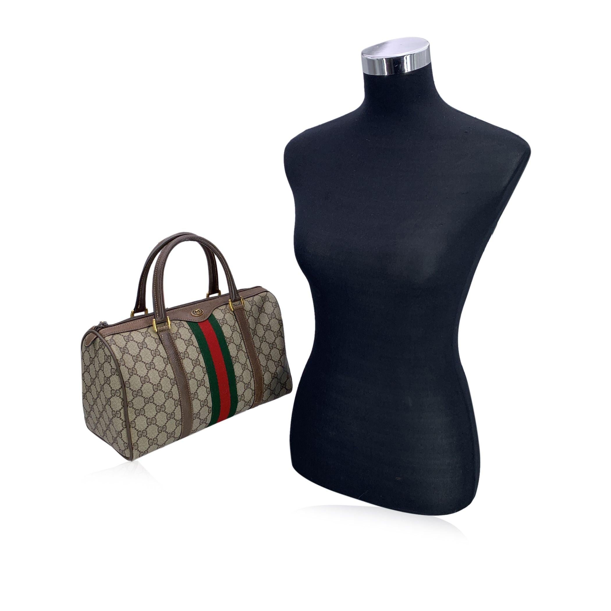 Gucci Vintage brown canvas and leather Monogram Web Boston Bag. Green/red/green stripes around the bag. Brown leather trim and handles. Double top handles. Upper zipper closure. Beige lining. 'GUCCI Accessory Collection - made in Italy' tag inside.