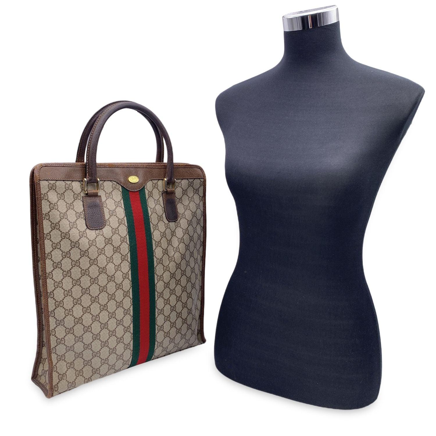 Beautiful Gucci tote made in brown monogram canvas with brown leather trim and handles. Green/Red/Green stripes on the front and on the back. Upper zipper closure. Beige lining. 1 side zip pocket inside. 'GUCCI Accessory collection - Made in Italy'