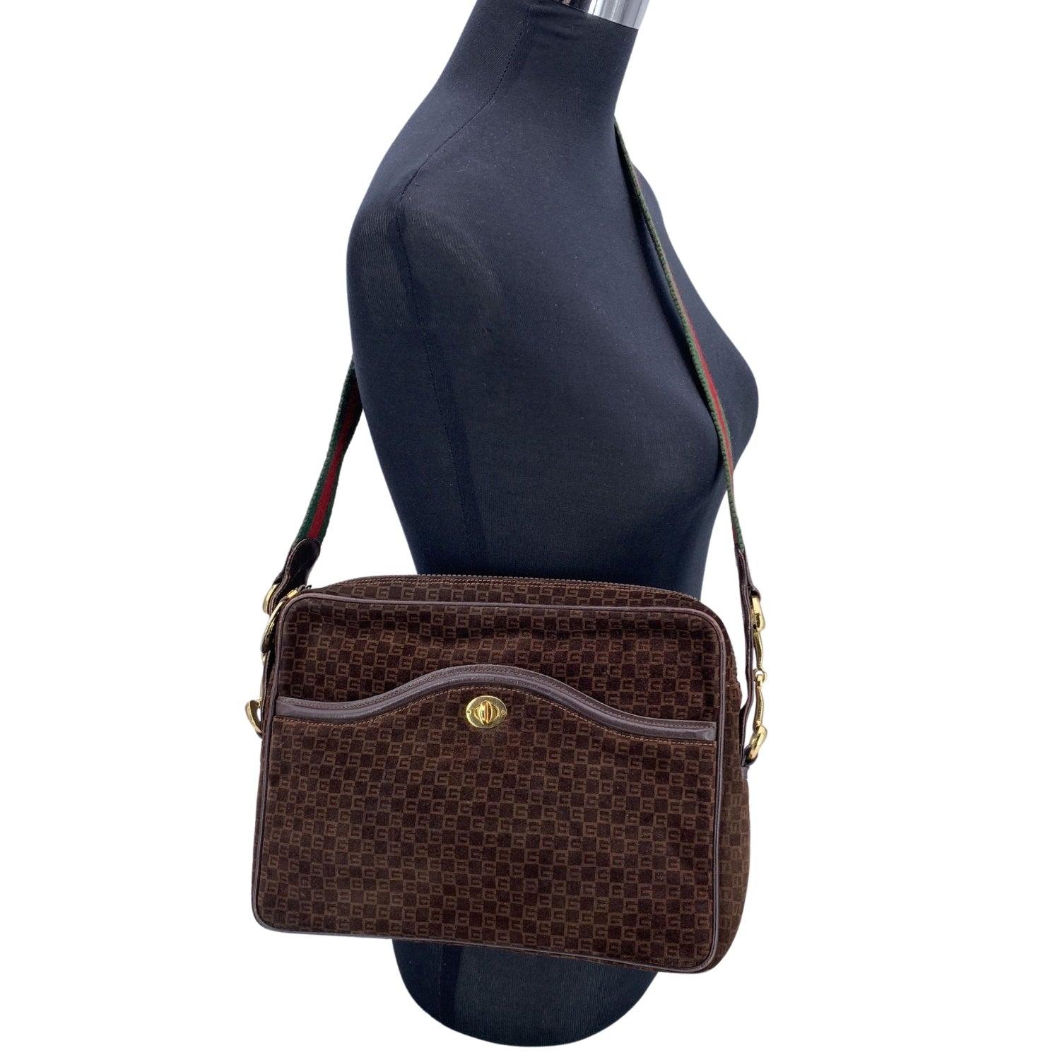 Step back in time with this exquisite vintage Gucci shoulder bag, a true testament to timeless style and exceptional craftsmanship. Made in Italy, this piece features a rich brown suede and brown leather exterior adorned with the iconic Gucci