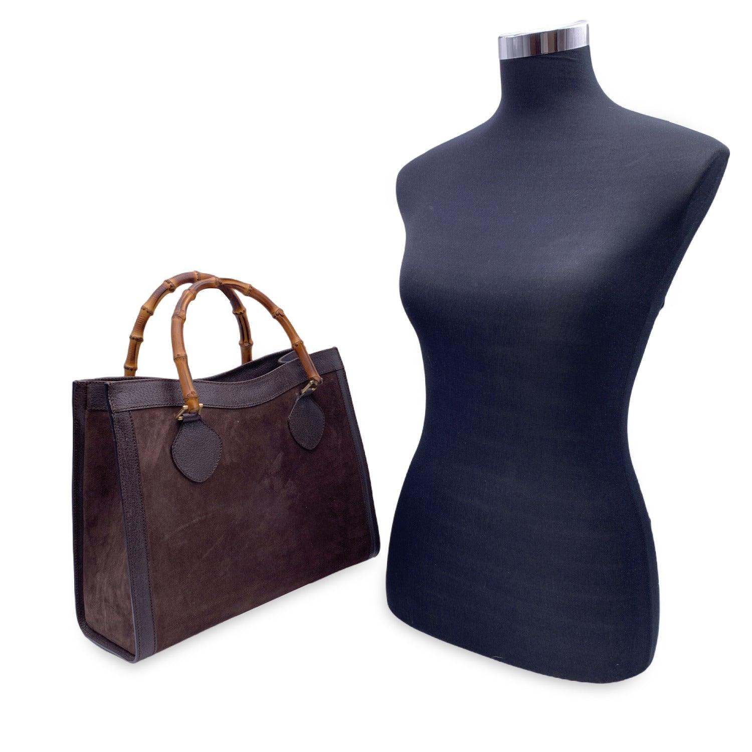Beautiful Gucci Bamboo tote bag in brown suede and leather. Double distinctive Bamboo handle. Princess Diana, was snapped carrying a this model on several occasions. Magnetic button closure on top. 5 bottom feet. Gold metal hardware. 1 Zip