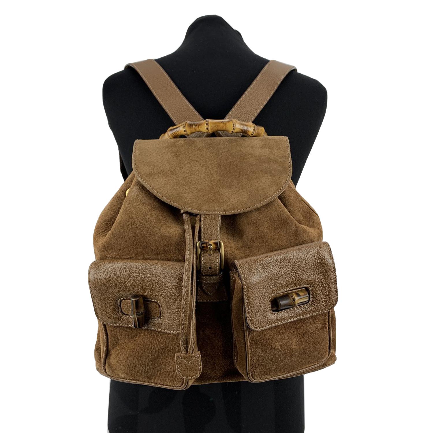 Vintage backpack by Gucci, crafted in brown suede and leather. It features Bamboo handle and knobs. 2 front flap pockets.Flap with buckle closure and drawstring top opening. Internal diamond lining. 1 side zipper pocket inside (GUCCI - GG gold metal
