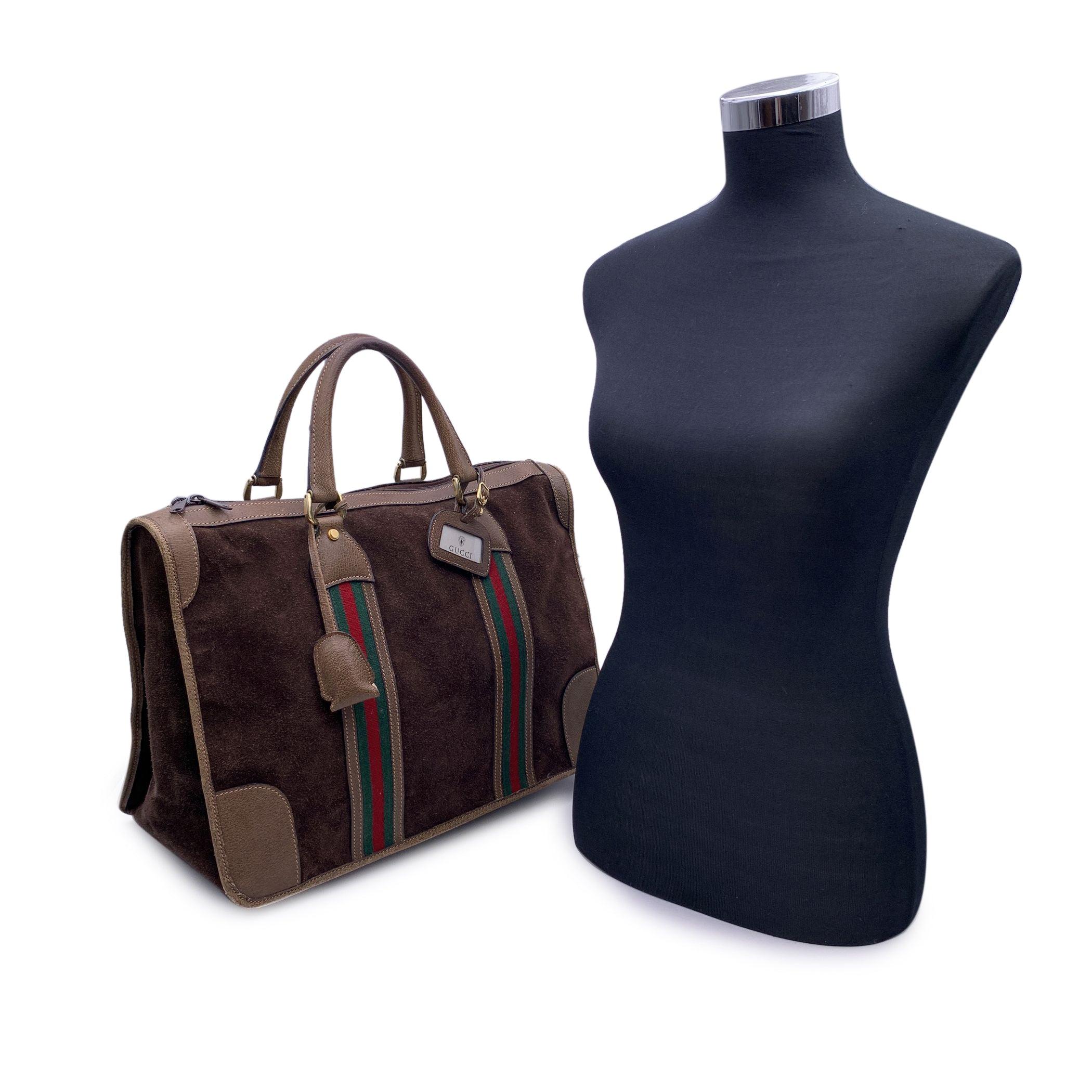 Beautiful Gucci satchel made in brown monogram canvas with brown leather trim and handles. Green/Red/Green stripes on the front and on the back. Leather ID tag attached. Padlock keys and leather clochette included. Upper zipper closure. Yellow