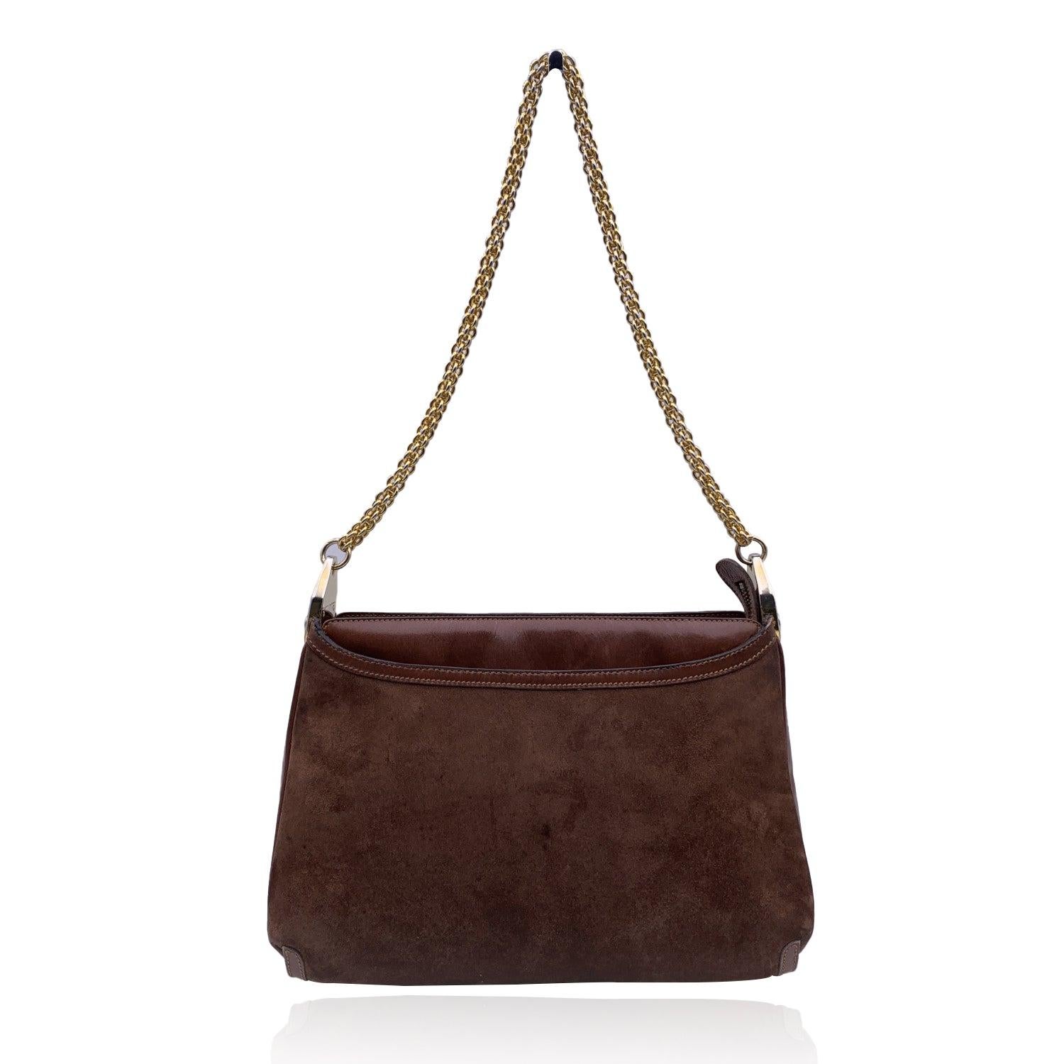 Gucci vintage shoulder bag. Brown suede and leather. Upper zipper closure. Gold metal chain strap. Brown leather lining. 1 middle zip section and 2 exterior open pockets. Brown leather lining. 1 side zip pocket inside. 'Made in Italy by Gucci'