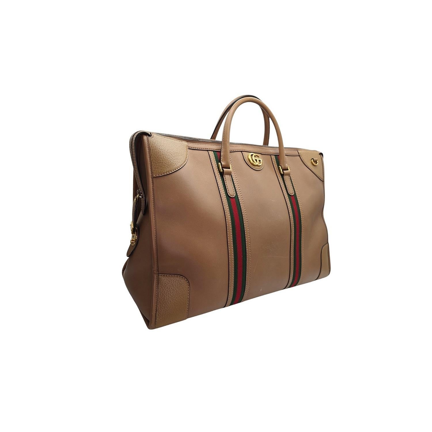Expertly crafted with luxurious calfskin leather with web details, the Gucci Bauletto XL Duffle Bag is a statement piece perfect for any travel or everyday use. With a spacious interior and multiple zip pockets, this bag offers both style and