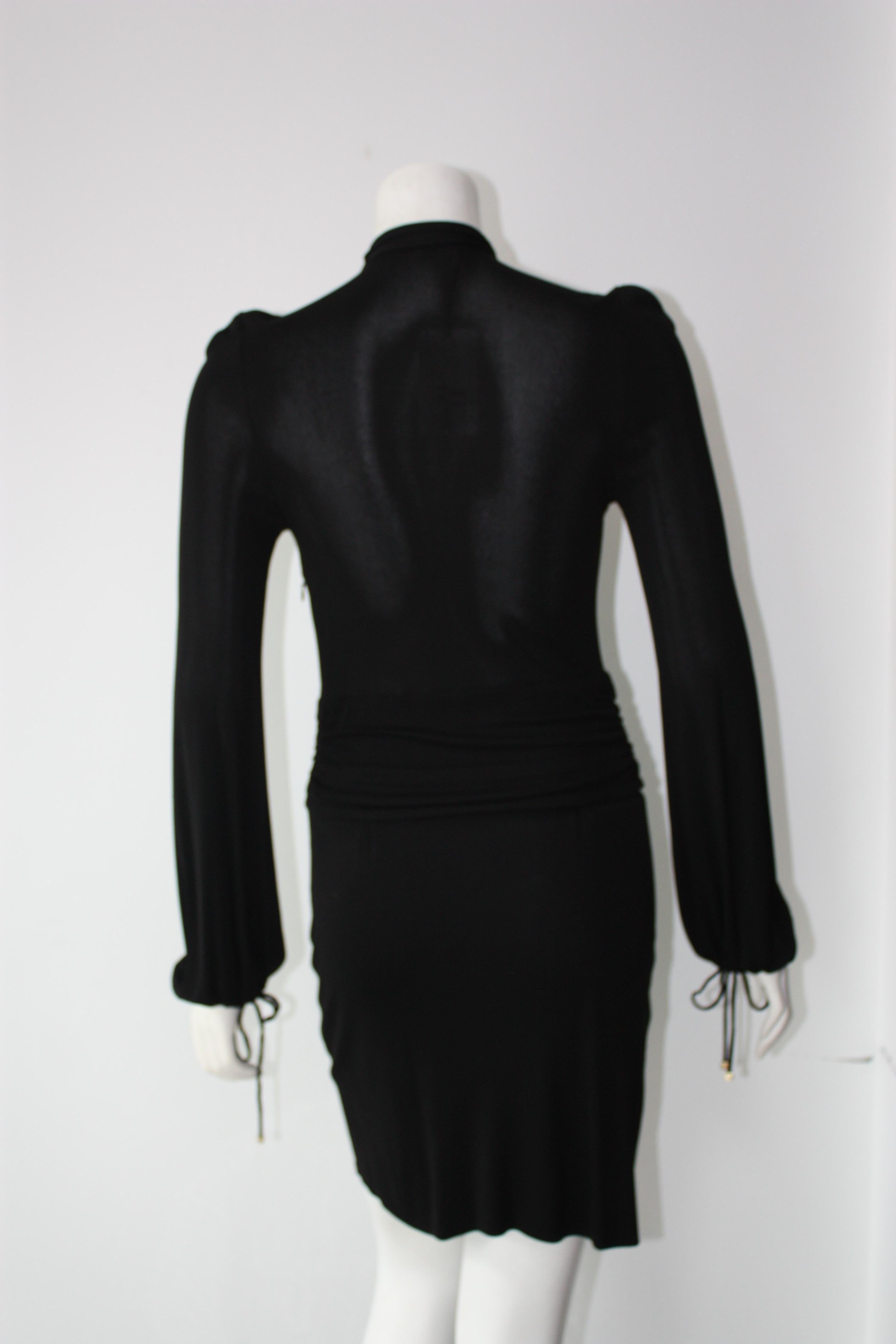 GUCCI vintage black long sleeve cocktail dress. Front deep V neckline with adjustable neckline clasp. Front ties with silver chain tassels. Sleeves have drawstring closure. Side zip.

Materials tag not present.
Size M