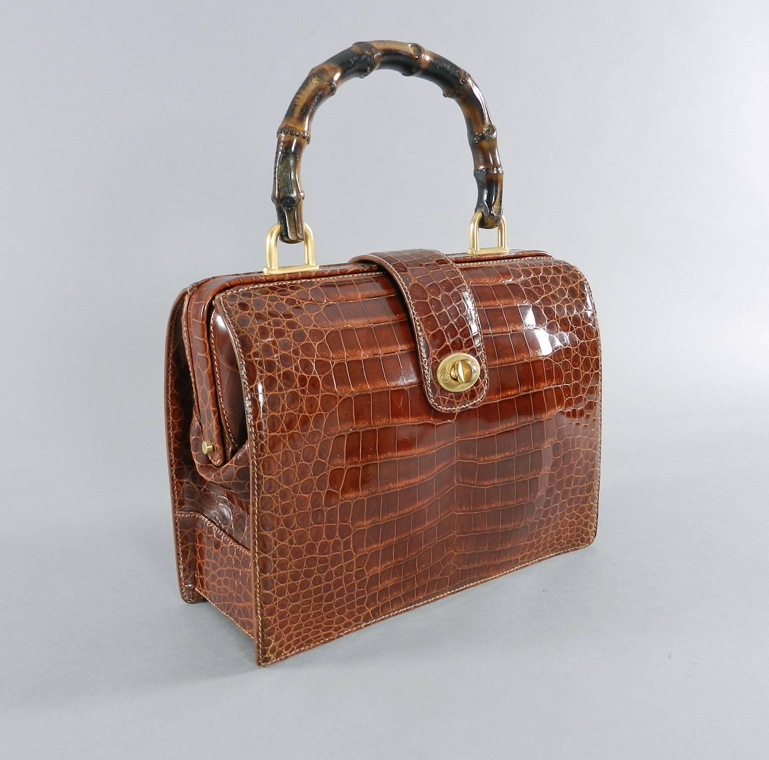 Gucci vintage cognac crocodile doctor bag with bamboo handle. Circa late 1990's. Suede lined, matte goldtone hardware, fastens with turnclasp, and has hinged frame.  Body of purse measures 10.5 x 8 x 3.75 inches not including handle. Excellent