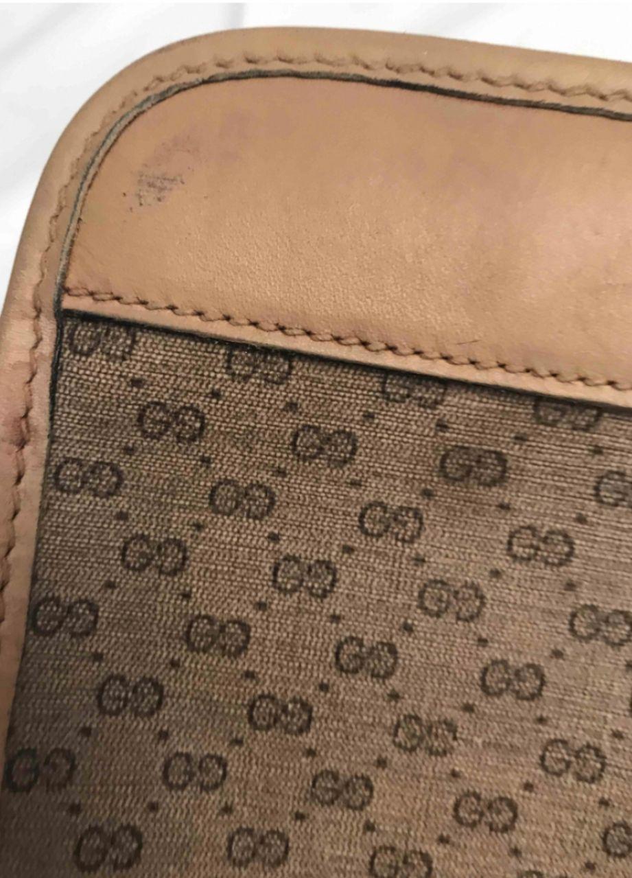 Vintage Gucci monogram suitcase with two-tone fabric band and dark brown leather inserts. Rare collector's item. It has some small signs of use as you can see from the photos but still very well maintained. It can be closed and the measures are