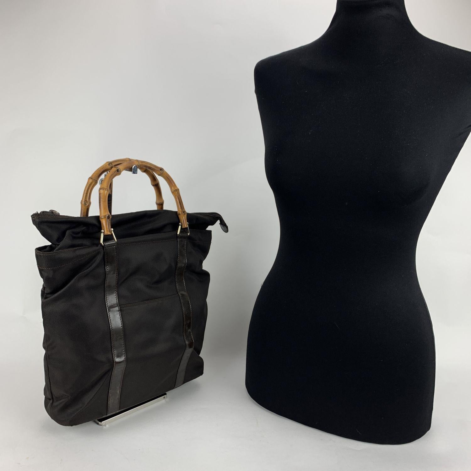 Vintage bamboo small tote by Gucci, crafted in brown canvas with patent leather trim. It features Bamboo handles, 1 front pocket, upper zipper closure, diamond lining and 1 side zip pocket inside. 'GUCCI - Made in Italy' tag (with serial number on