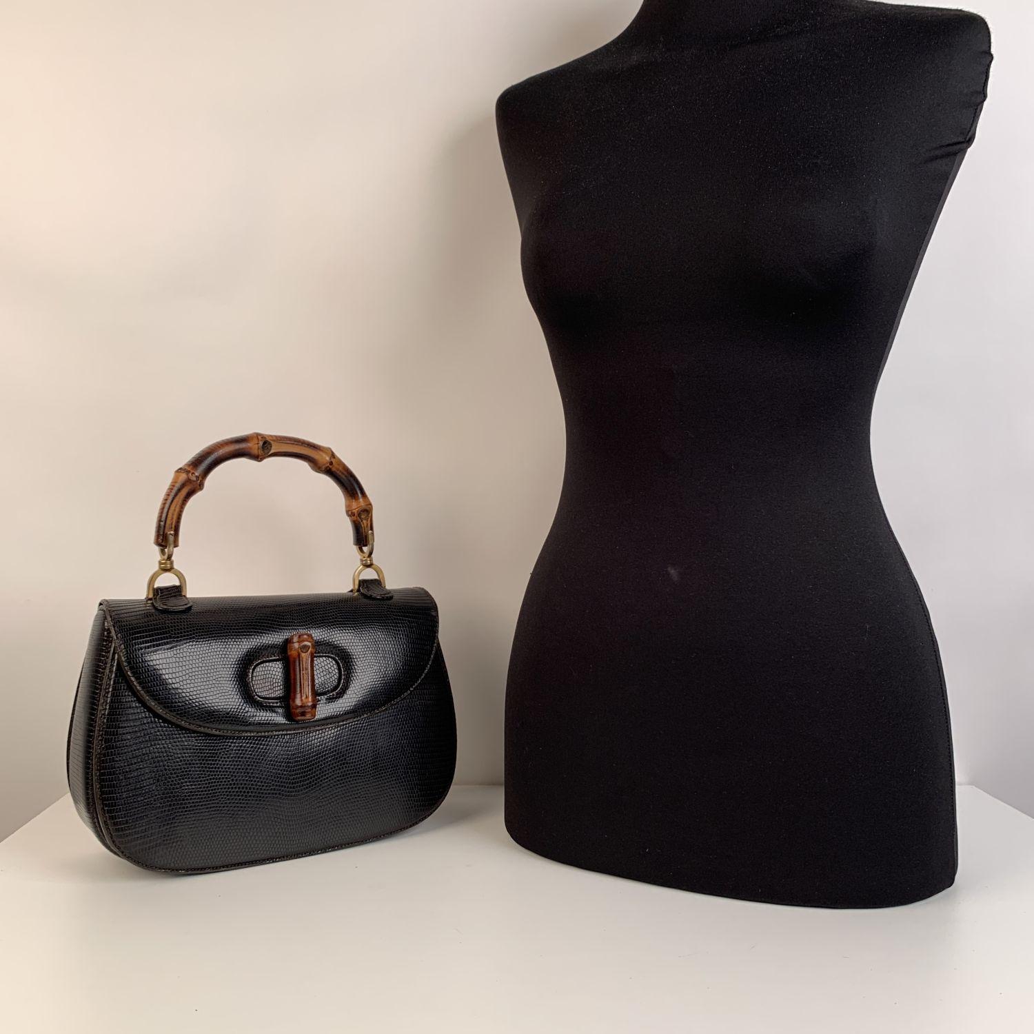 Rare GUCCI vintage Leather bamboo bag in dark brown (very dark, it look like black) lizard leather. The bag features a looping bamboo top handle, a frontal flap, brass hardware and a bamboo turn lock. This is an iconic model created by GUCCI