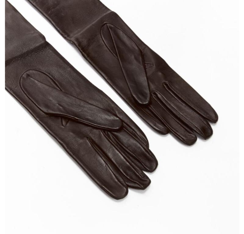 GUCCI Vintage dark brown leather gold stud trim long gloves Sz.7
Reference: ANWU/A00892
Brand: Gucci
Designer: Tom Ford
Material: Calfskin Leather
Color: Brown, Gold
Pattern: Solid
Lining:  Unlined
Made in: Italy

CONDITION:
Condition: Very good,