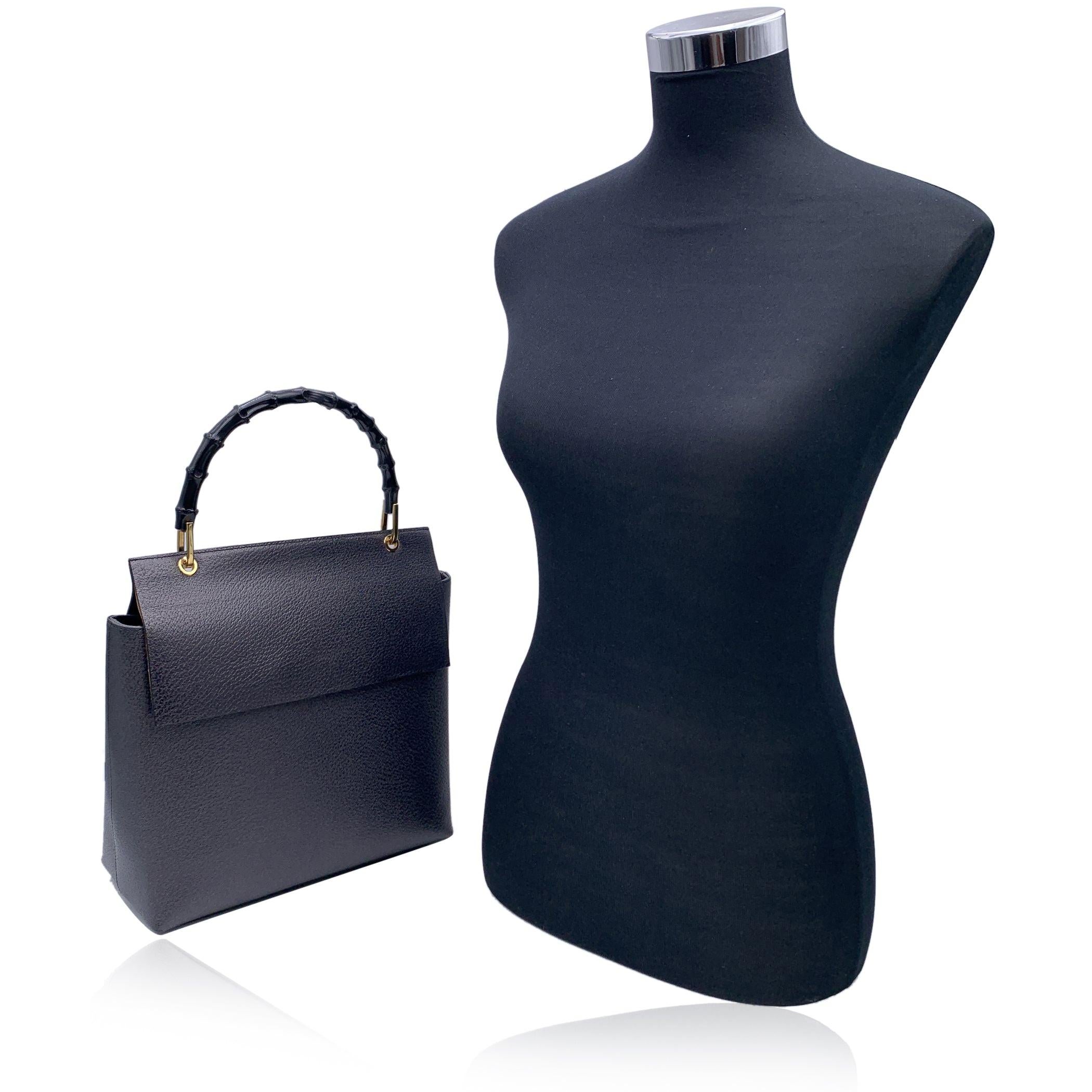 Beautiful Gucci Bamboo handbag in dark grey leather. Leather has a light metallic effect. Structured design. Single distinctive Bamboo handles painted in black. Gold metal hardware. Flap with magnetic button closure. Grey suede lining. 1 side zip