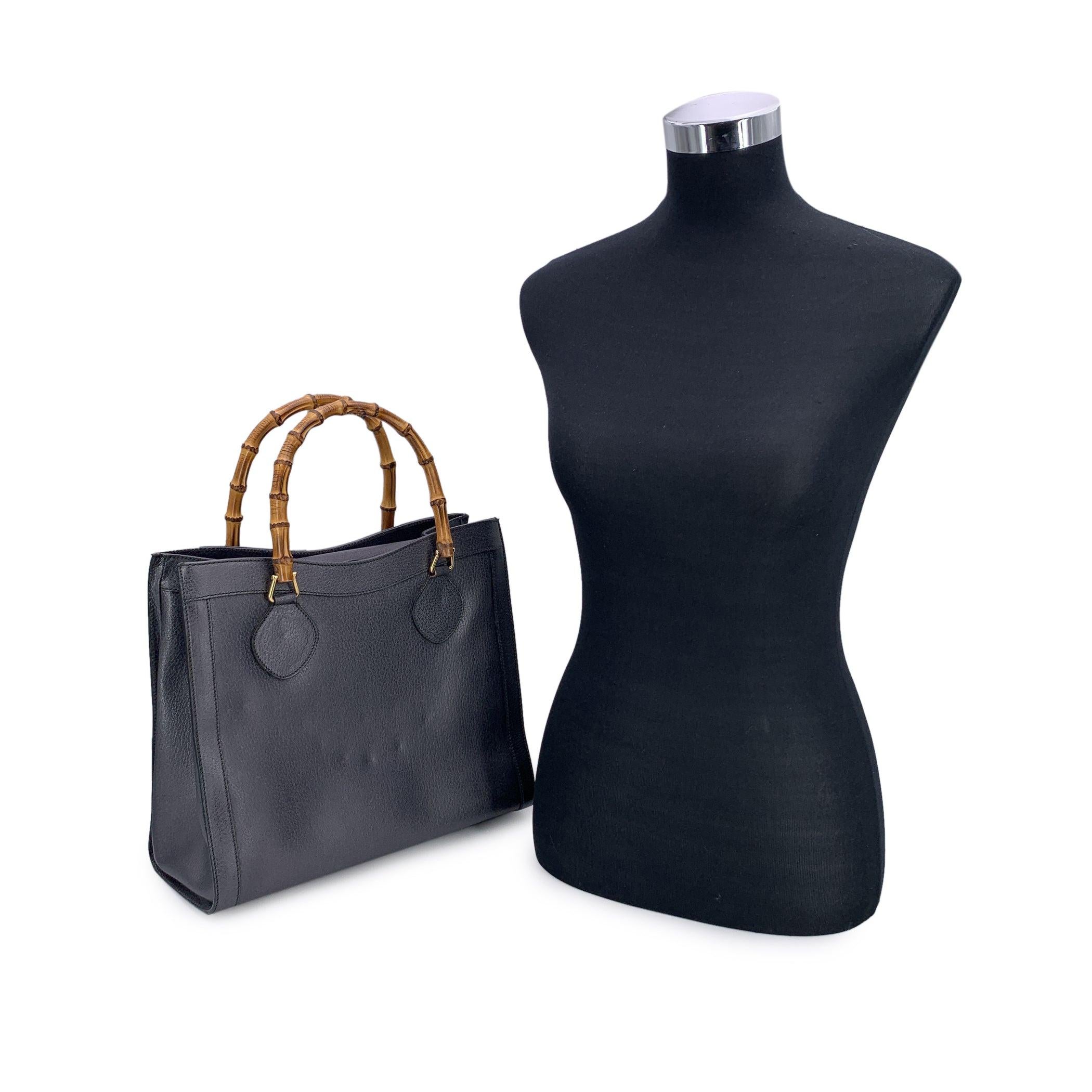 Step into the world of timeless elegance with this stunning vintage Gucci Bamboo tote bag, crafted in rich dark grey/gunmetal leather. This luxurious piece boasts the iconic double bamboo handles, a distinctive feature that truly sets it apart. A