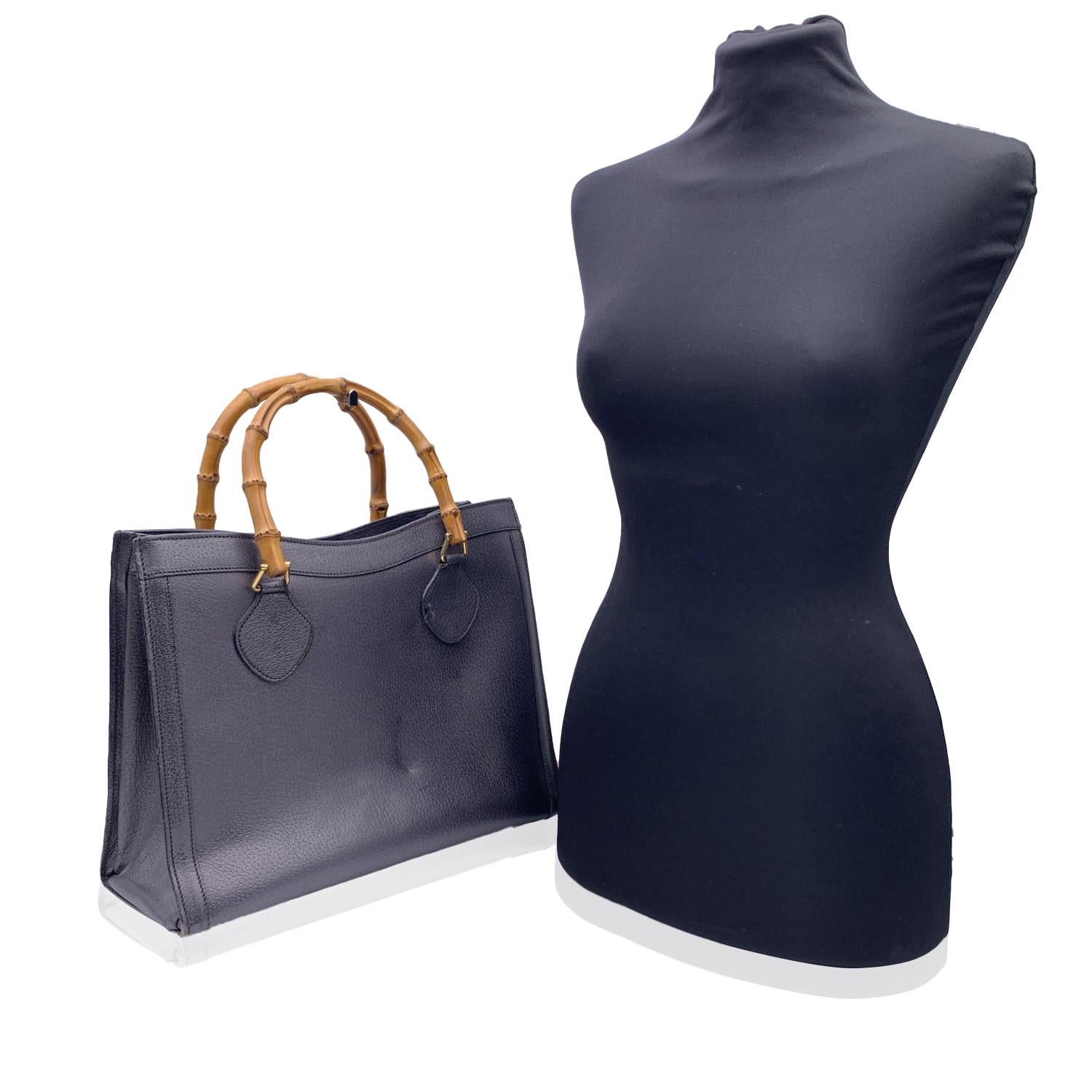 Beautiful Gucci Bamboo tote bag in dark grey/gunmetal leather. Double distinctive Bamboo handle. Princess Diana, was snapped carrying a this model on several occasions. Magnetic button closure on top. 5 bottom feet. Gold metal hardware. 1 Zip