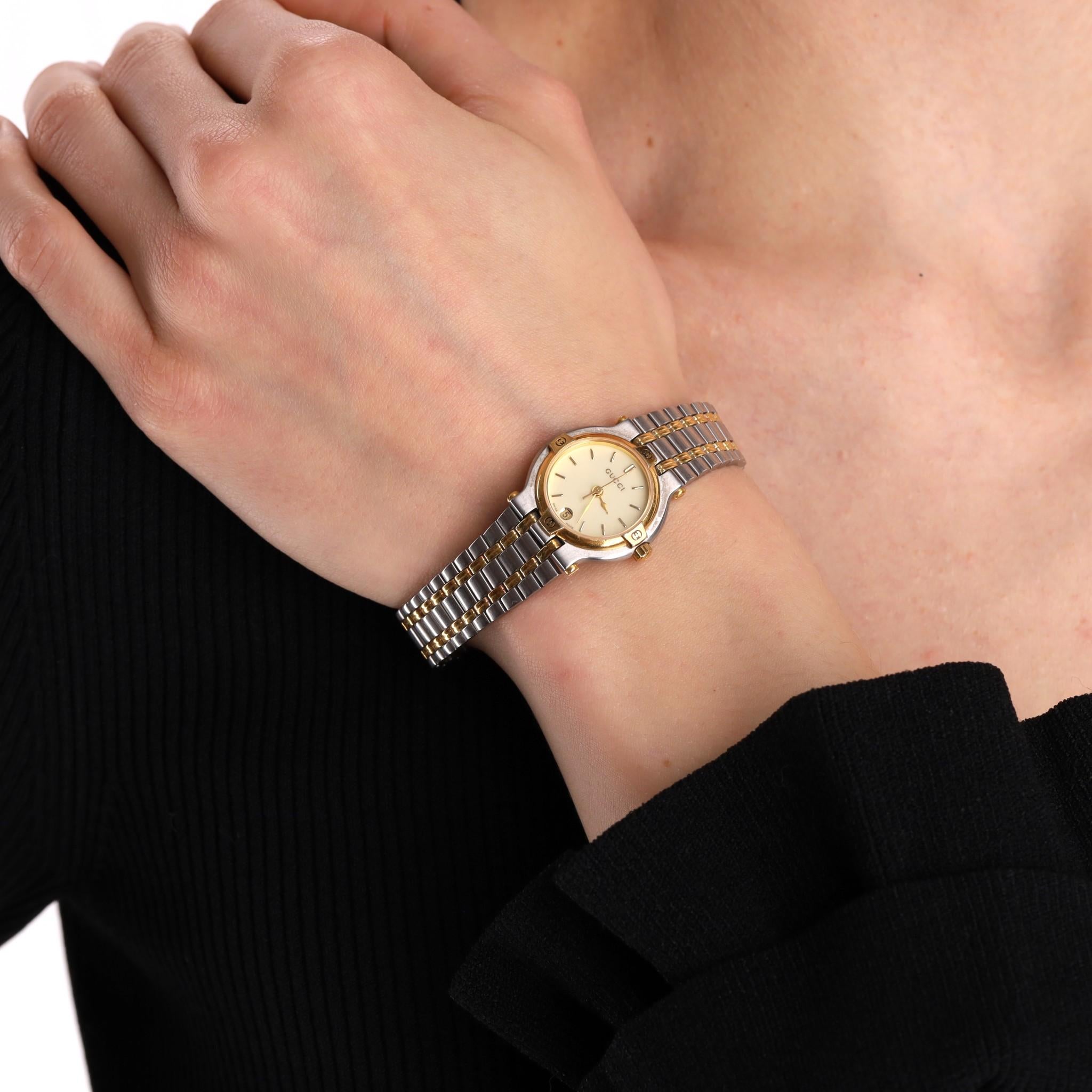 Gucci Vintage Date 9000L Two-Tone Stainless Steel & Gold Watch

From 1995 is this vintage piece set in a stainless steel case with gold plated dial adorned with iconic, vintage 'GG' logos.

Featuring ivory face detailed with gold stick hour markers