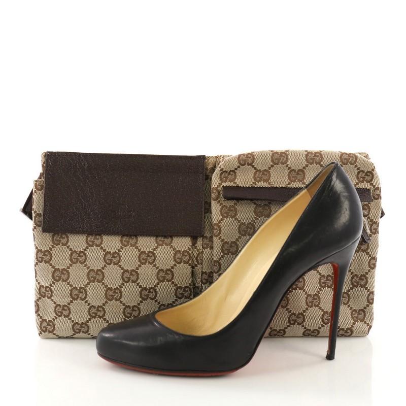 This Gucci Vintage Double Belt Bag GG Canvas, crafted in brown GG canvas, features an adjustable textile strap, front zip and snap pockets, and silver-tone hardware. Its zip closure opens to a black fabric interior. **Note: Shoe photographed is used