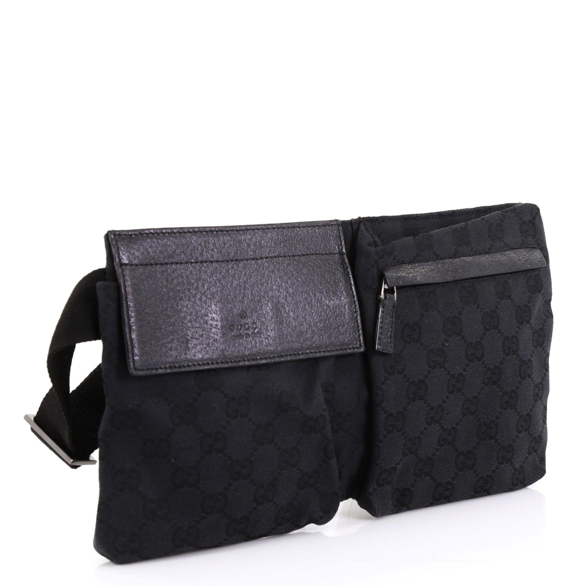 This Gucci Vintage Double Belt Bag GG Canvas, crafted in black GG canvas and leather, features an adjustable textile strap, front zip and snap pockets, and gunmetal-tone hardware. Its zip closure opens to a black fabric interior. 

Condition: Great.