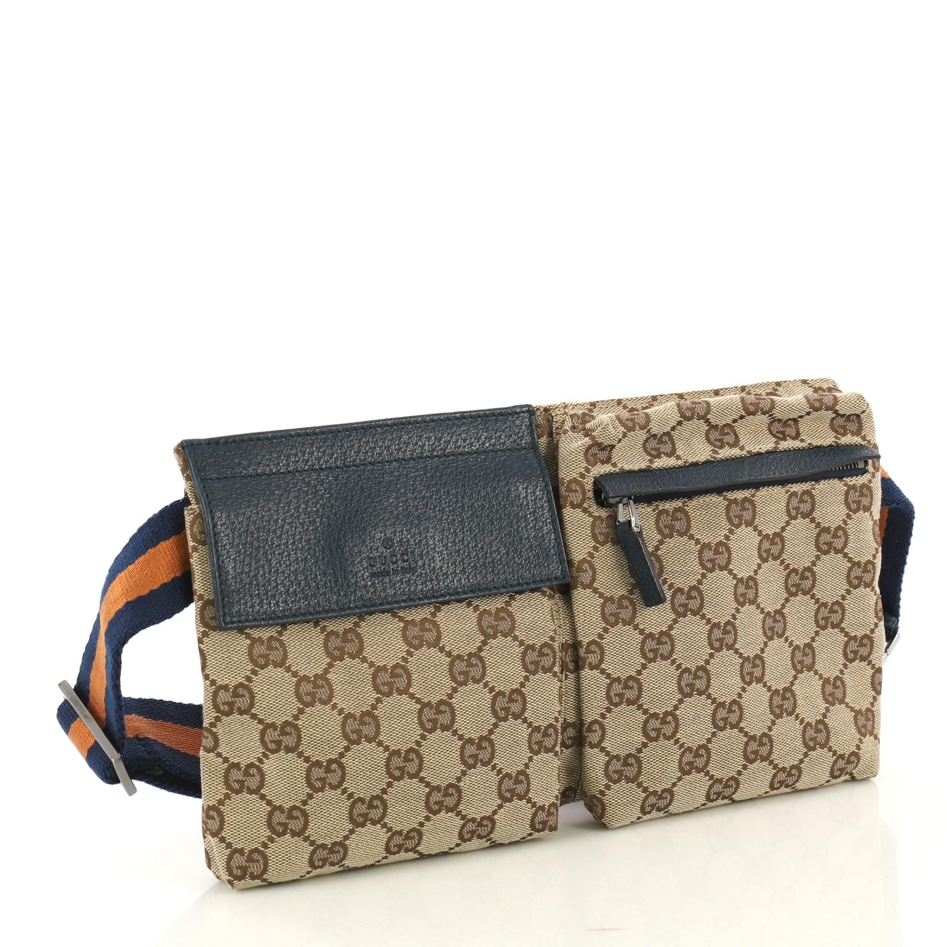 This Gucci Vintage Double Belt Bag GG Canvas, crafted in brown GG canvas, features an adjustable textile strap, front zip and snap pockets, and gunmetal-tone hardware. Its zip closure opens to a blue fabric interior. 

Condition: Great. Minor scuffs