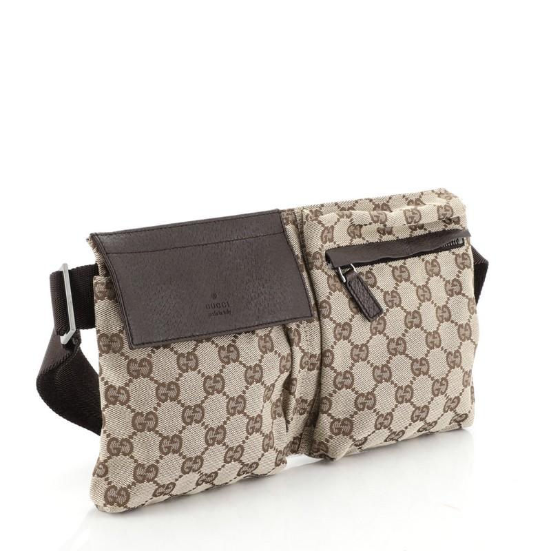 This Gucci Vintage Double Belt Bag GG Canvas, crafted in brown GG canvas, features an adjustable textile strap, front zip and snap pockets, and gunmetal-tone hardware. Its zip closure opens to a brown fabric interior. 

Condition: Excellent. Slight