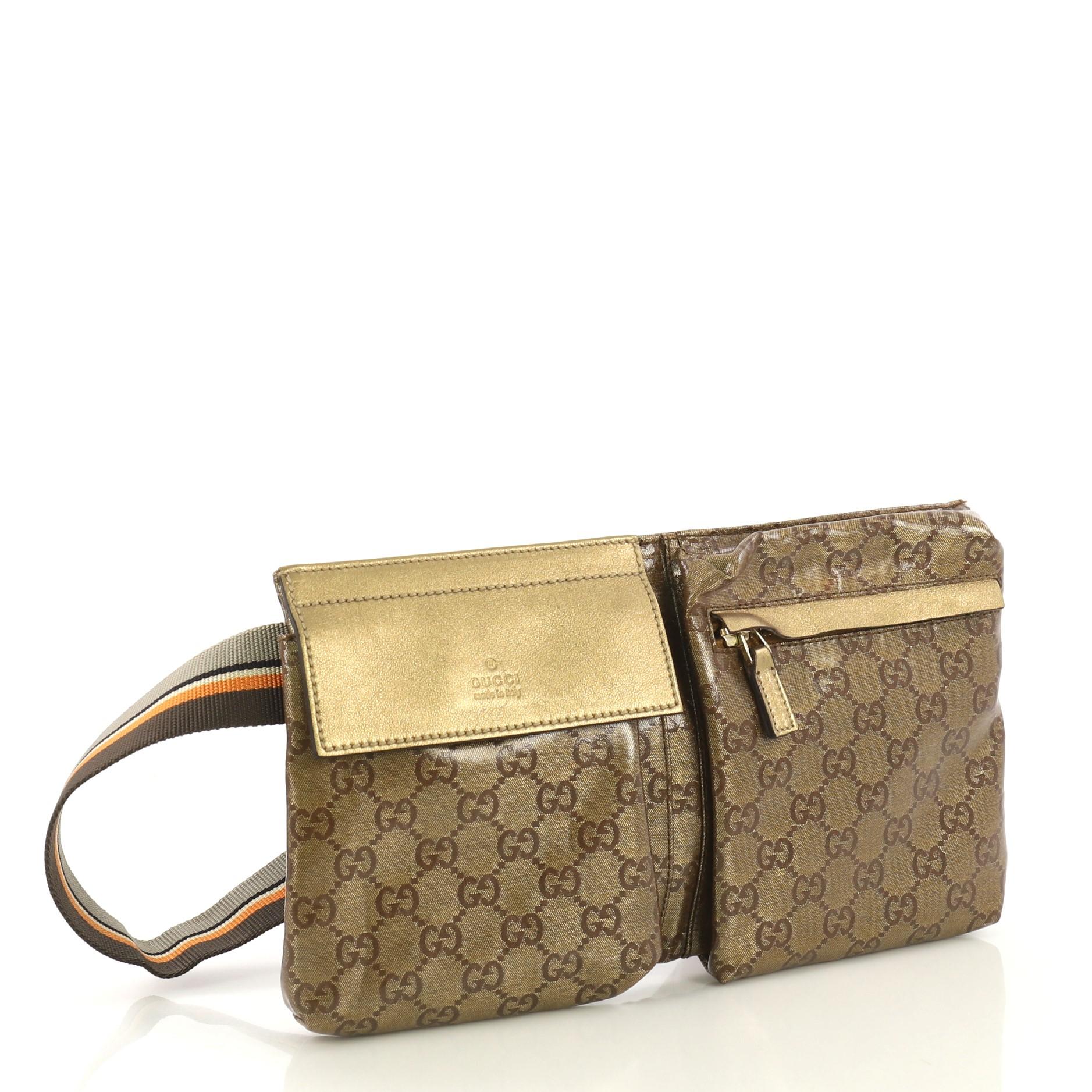 This Gucci Vintage Double Belt Bag GG Coated Canvas, crafted in gold metallic GG coated canvas, features an adjustable textile strap, front zip and snap pockets, and gold-tone hardware. Its zip closure opens to a brown fabric interior. 

Condition: