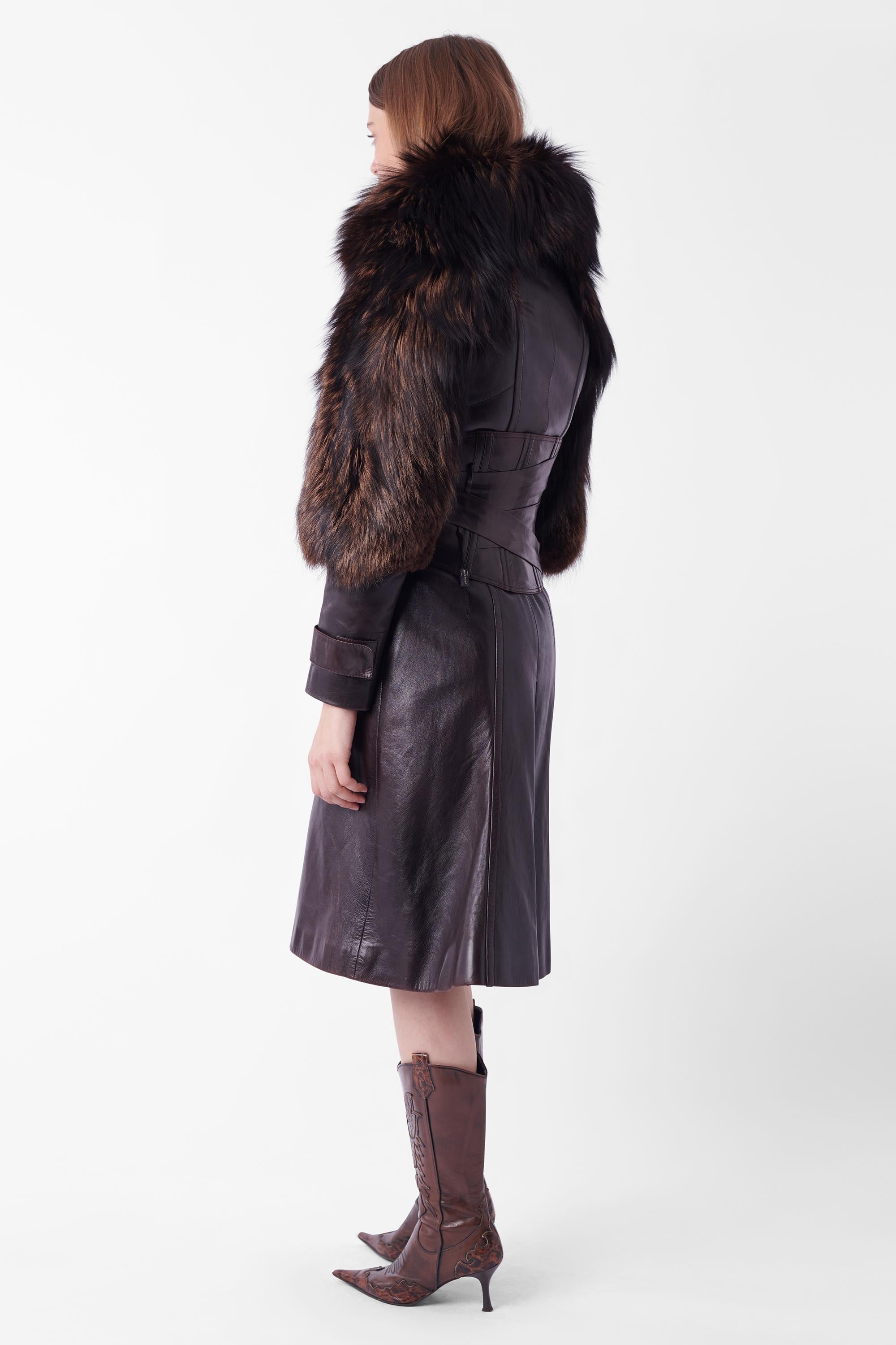 Nordic Poetry is very excited to present this incredible Tom Ford for Gucci Fall Winter 2003 leather coat with fur trimming  and corset belt, runway look 26. Coat features seaming, double front pockets, button wrist cuffs, fur arms and collar. Belt