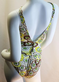 Gucci vintage flowers enhances a sparkling swimsuit in light summerly colours