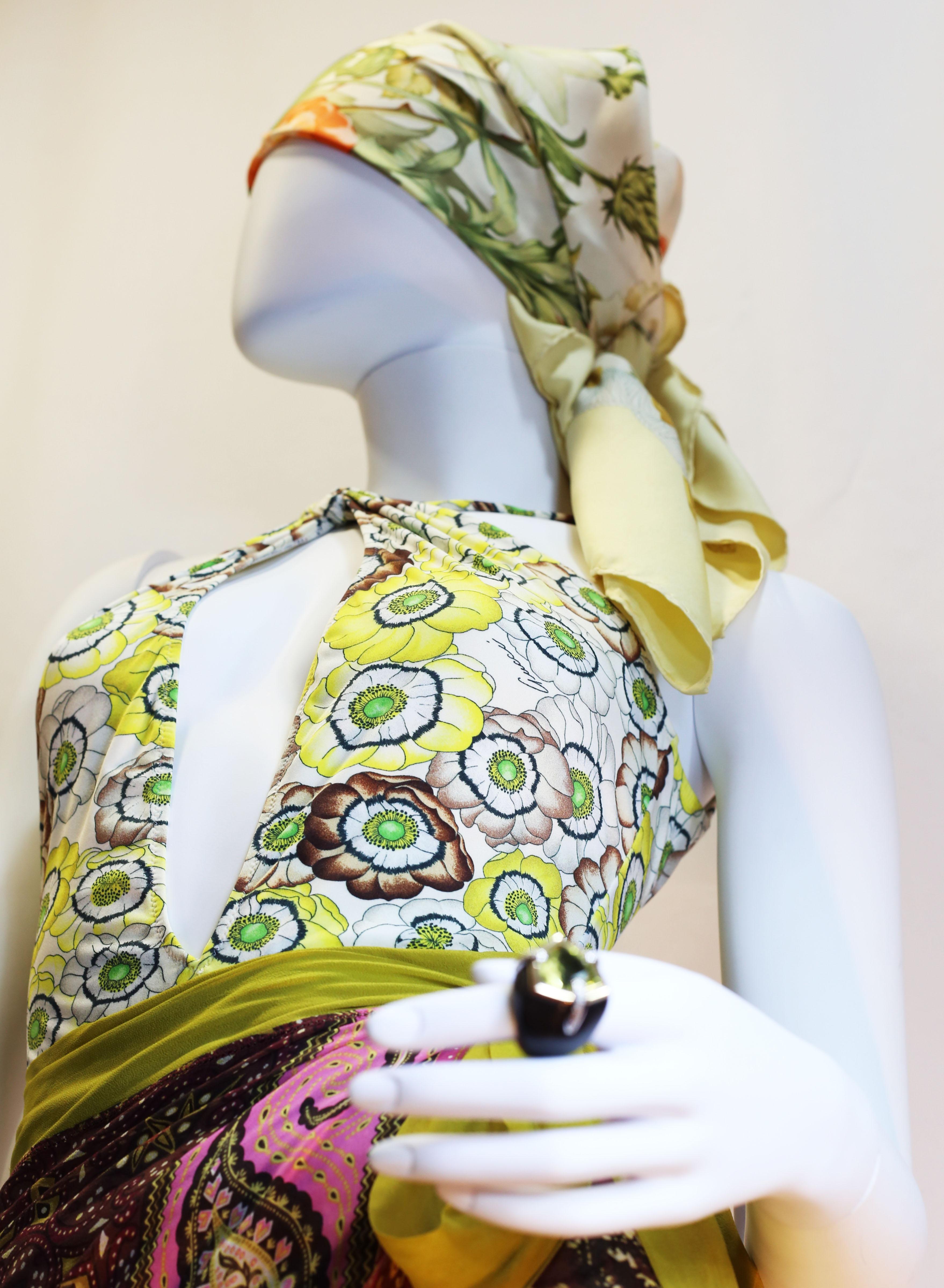Beige Gucci vintage flowers enhances a sparkling swimsuit in light summerly colours 
