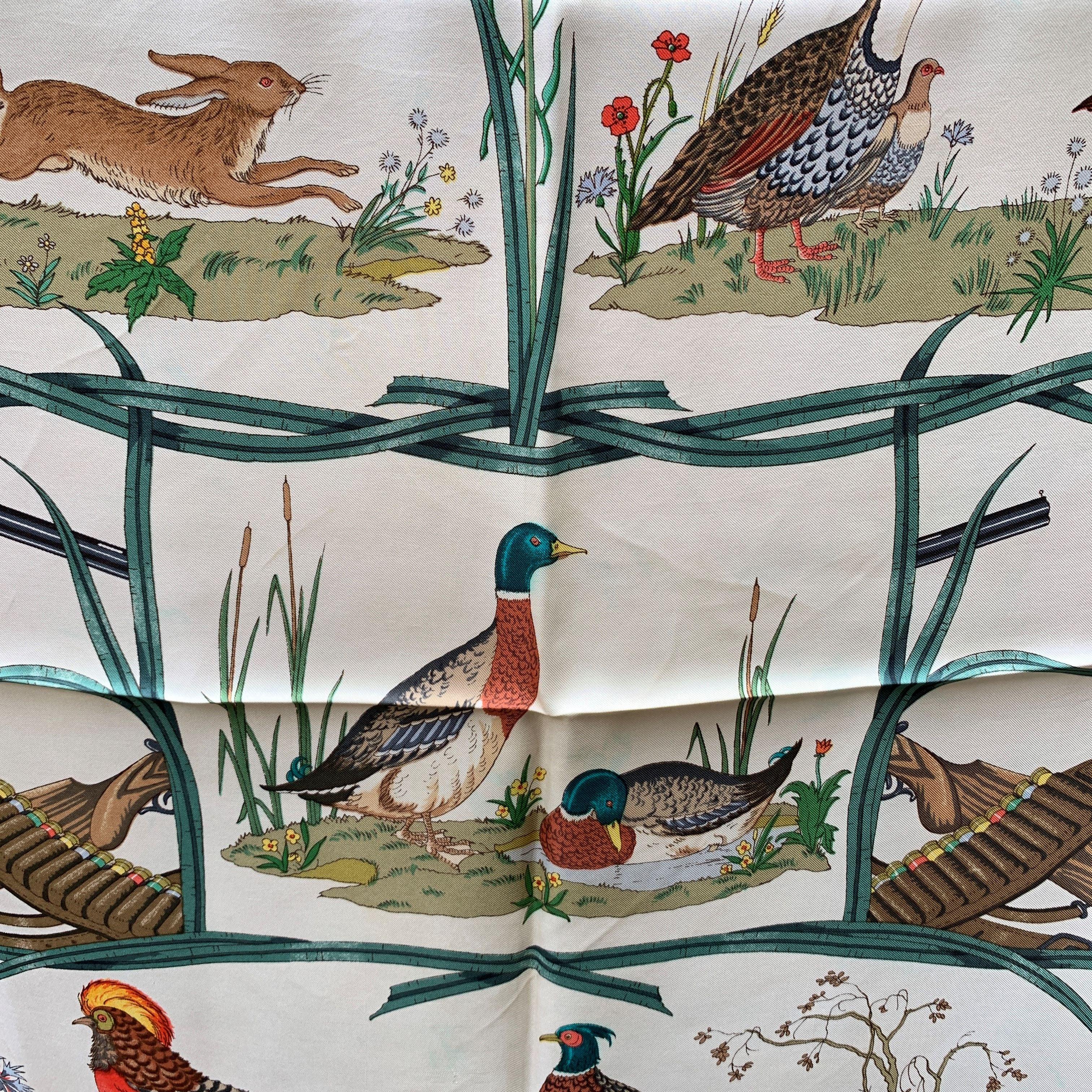 Vintage Gucci silk scarf designed by the artist Vittorio Accornero. He was the textile designer for Gucci between the 1960s and 1981. It depicts images of game (pheasants, mallards, partridges, hares), surrounded by various flowers (buttercups,