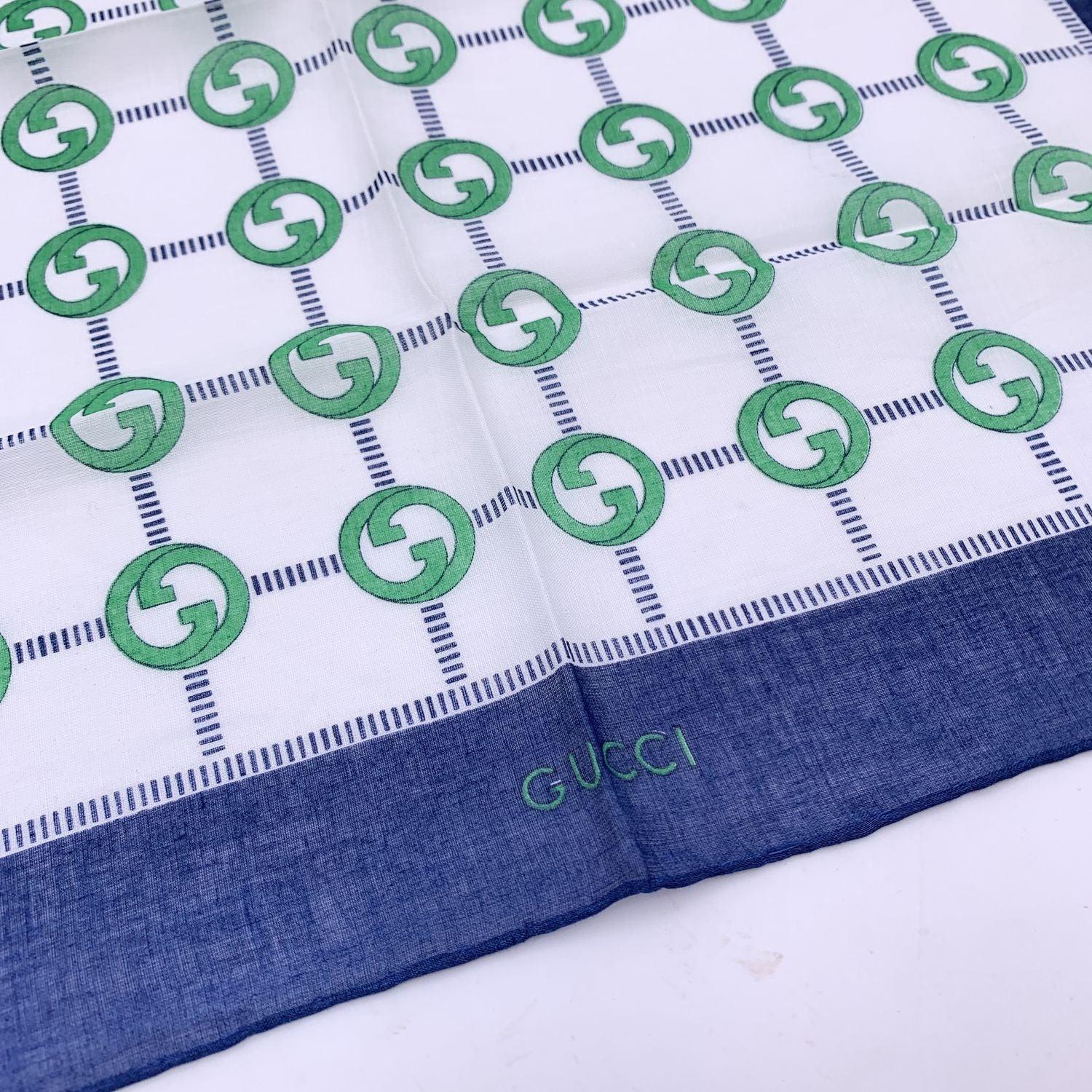 Vintage neck scarf by GUCCI. 100% Cotton. Green GG logos with blue borders. 'Gucci' signature printed on the lower center border. Approx. Measurements: 16.5 x 16.5 inches - 42 x 42 cm Details MATERIAL: Cotton COLOR: Blue MODEL: n.a. GENDER: Women