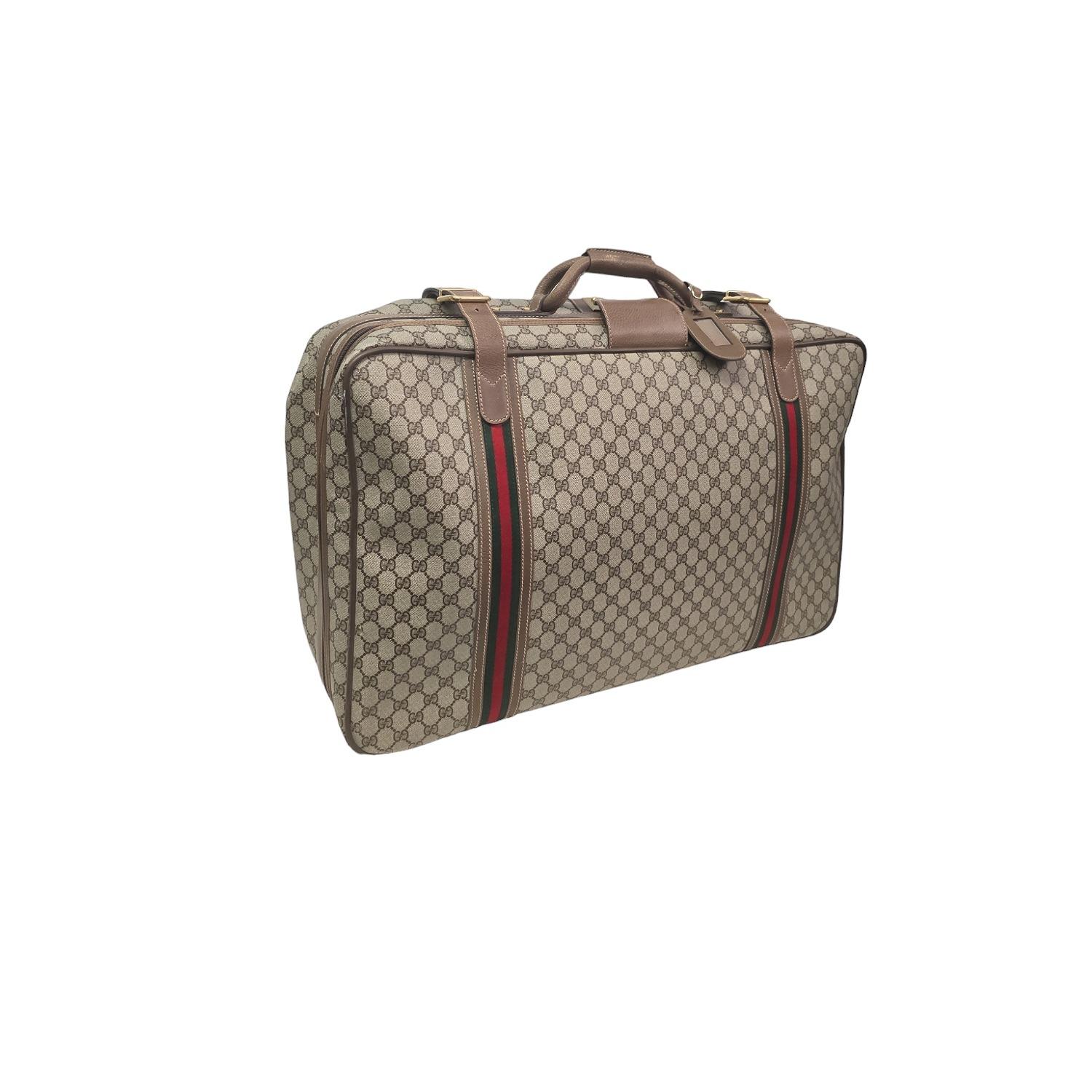 Discover the timeless elegance of the Gucci Vintage GG Supreme Web Suitcase. Crafted in Italy from the iconic brown/beige 'GG' monogram coated canvas and luxurious brown leather trim, this suitcase features gold-tone hardware and the classic green