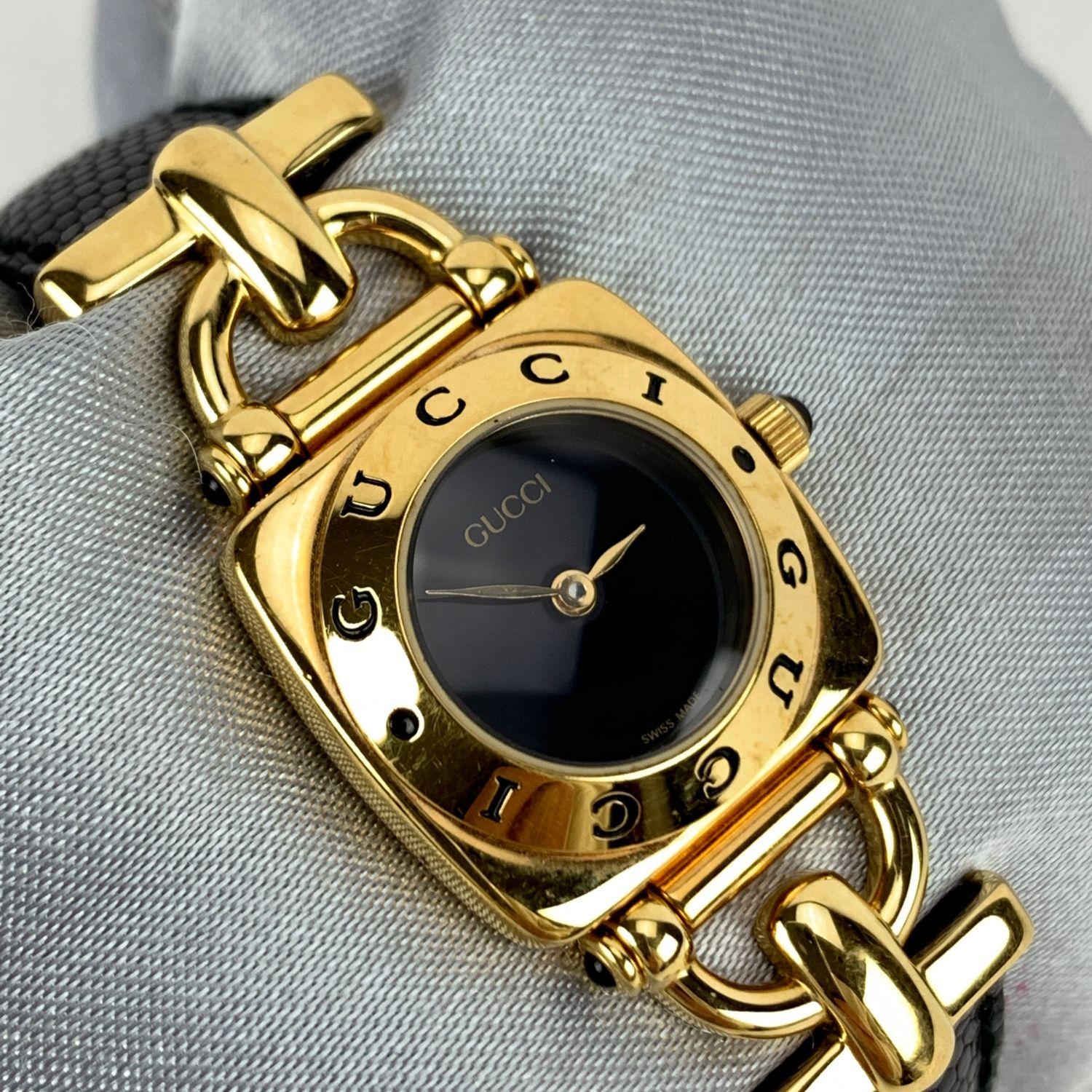 Gucci 6300 L Gold plated stainless steel wrist watch from the 90s. Black dial and Sapphire crystal. Swiss Made Quartz movement. Gucci written on face and on the bezel .Water Resistant to 3atm. Black leather trap with buckle closure (GG logo engraved