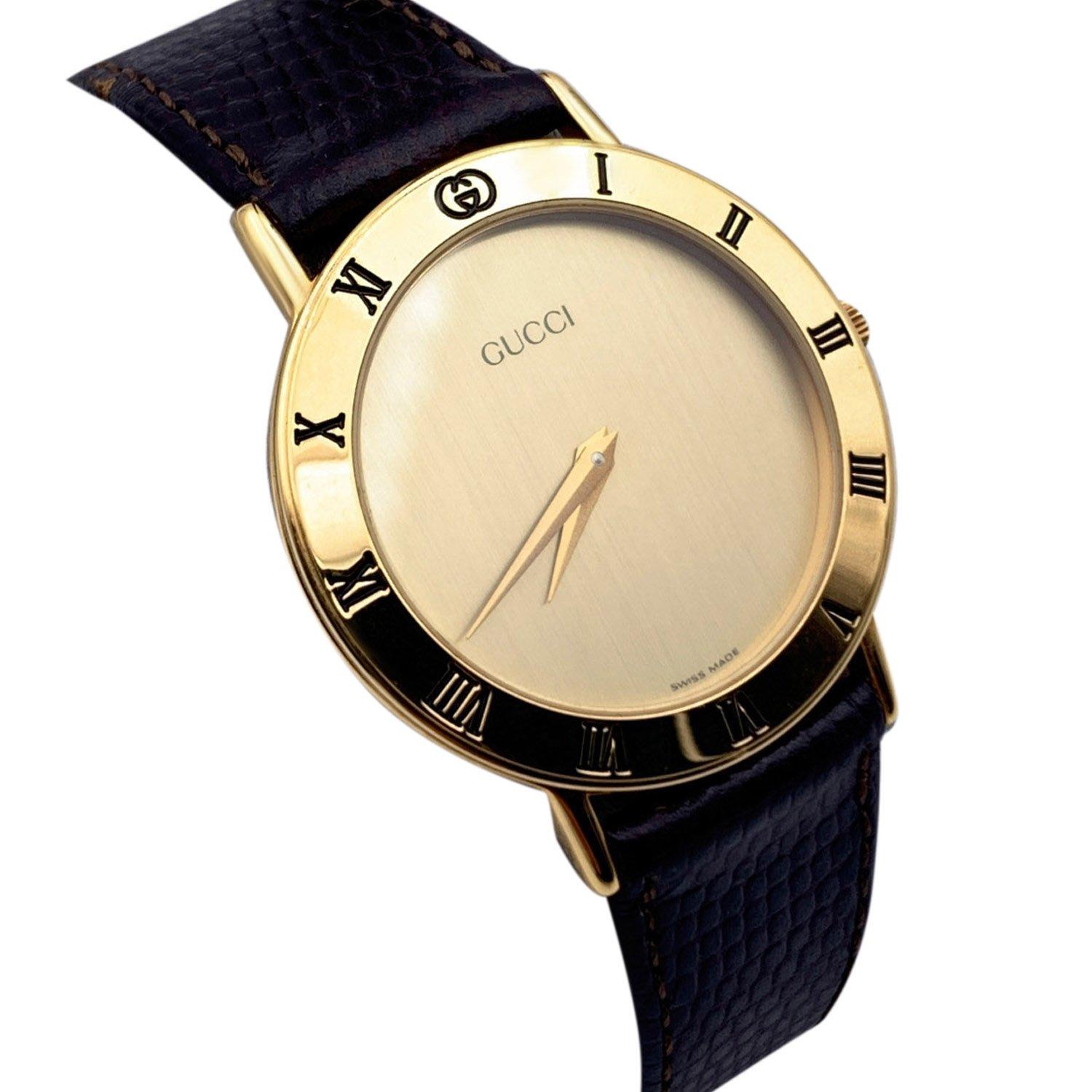 Beautiful vintage wristwatch by GUCCI. Round gold metal stainless steel case. Gold dial. Swiss Made Quartz Movement. Brown leather wrist strap with 6 holes adjustment. GG - GUCCI buckle. Roman numbers engraved on the bezel. 'GUCCI' lettering on the