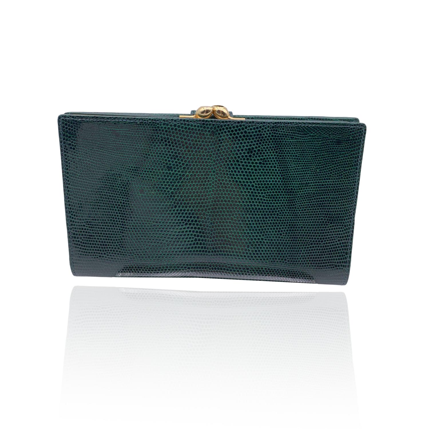 Vintage Gucci wallet, crafted in green leather. Fold over strap with gold metal GG - GUCCI logo with button closure. Green leather interior. Back coin compartment. It opens to 4 open pockets. 'Made in Italy by Gucci' embossed