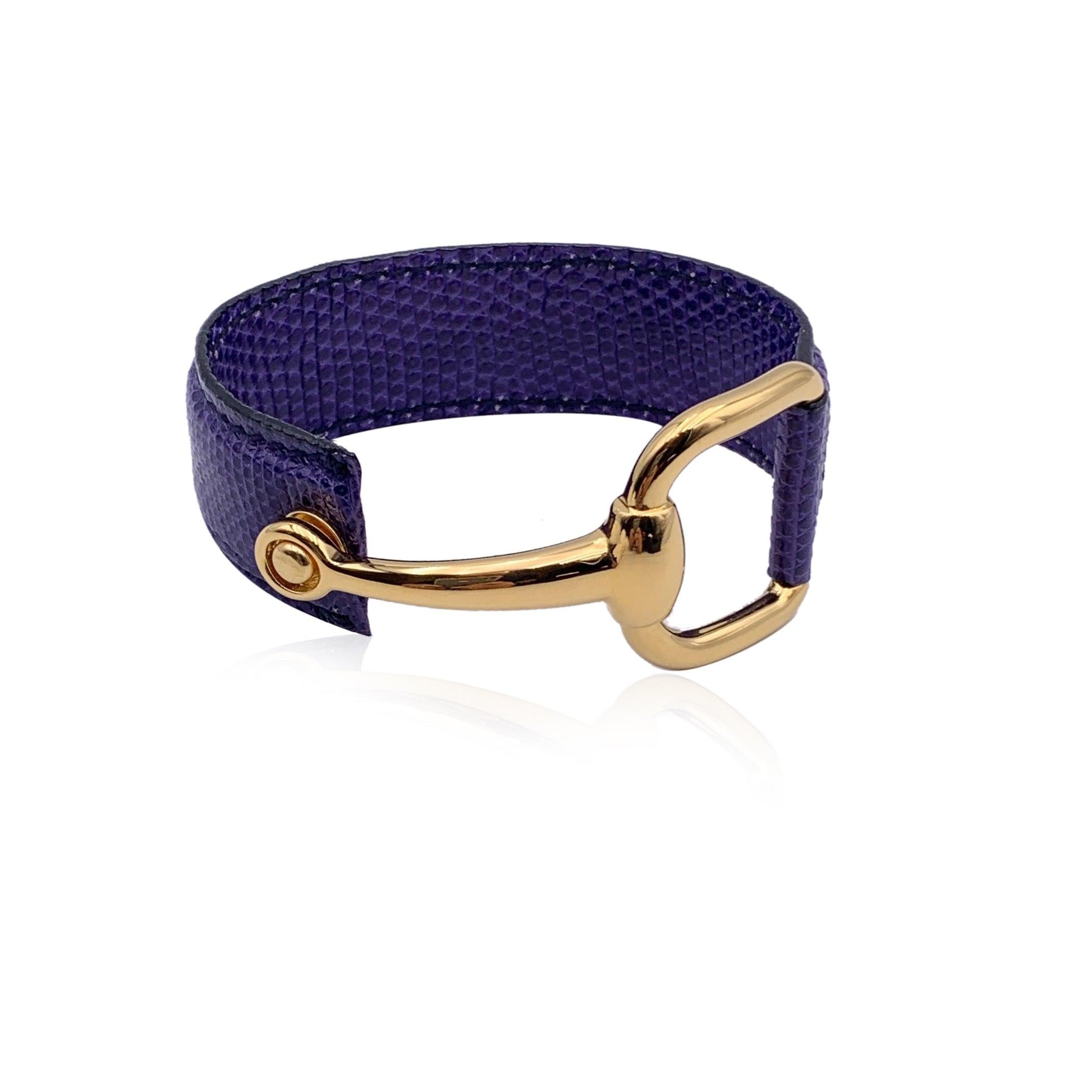 Vintage beautiful cuff bracelet by Gucci. Made in purple blue/indigo leather, it features an gold metal half-horsebit. Will fit up to approx. 6.5 inches - 16.5 cm wrist. Width: 0.75 inches - 2 cm. 'Gucci - made in Italy' engraved on the reverse of