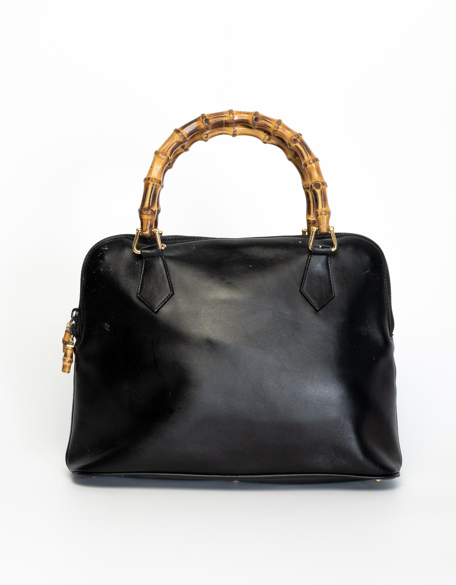 This Gucci handbag is made of leather with a top zipper and bamboo handles with a leather interior.

COLOR: Black
MATERIAL: Leather with bamboo top handle
ITEM CODE: 000 1448 0289
MEASURES: H 10” x L 14” x D 5”
DROP: 6”
COMES WITH: Dust
