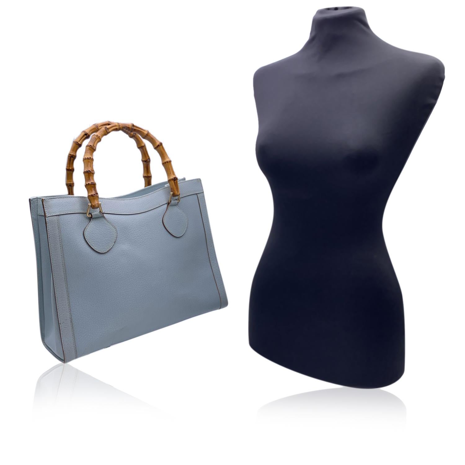 Beautiful Gucci Bamboo tote bag in light blue leather. Double distinctive Bamboo handle. Princess Diana, was snapped carrying a this model on several occasions. Magnetic button closure on top. 5 bottom feet. Gold metal hardware. 1 compartment in the