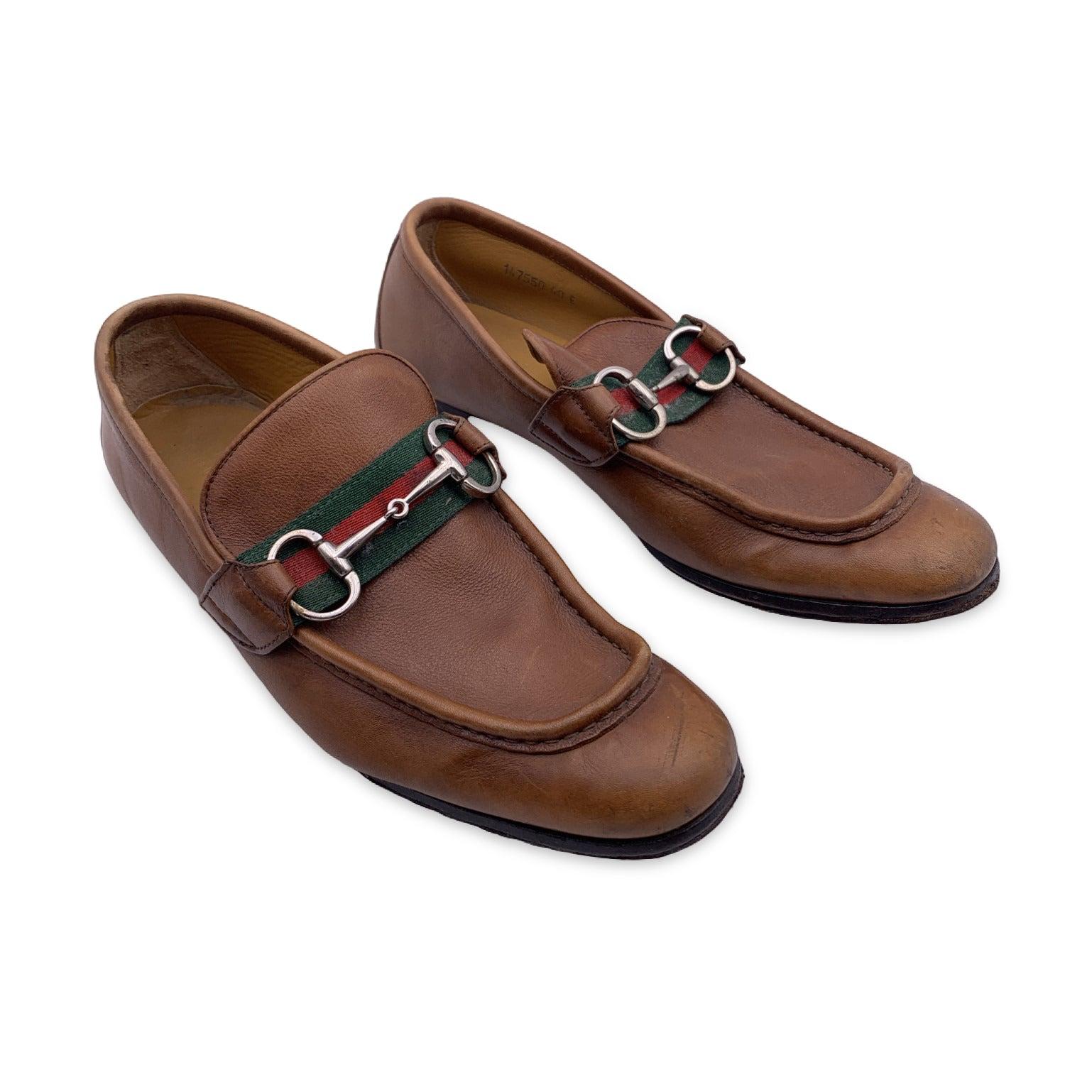 Light brown Leather loafers by GUCCI designed with a almond toe. Light brown leather with green and red Web detail. Horsebit detail on the toes. Leather outsoles. Made in Italy. Size: 40 (The size shown for this item is the size indicated by the
